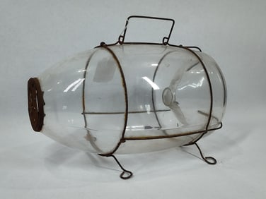 Early glass minnow trap with original wire carrier