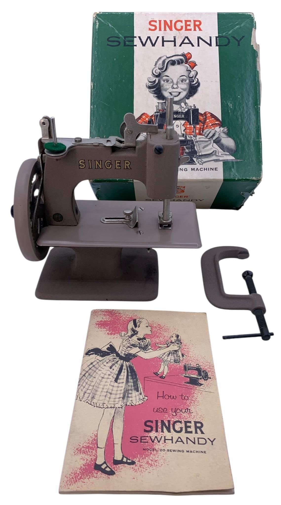 1953 Singer Sewhandy Child Size Model No 20 Working Mechanical Sewing Machine: Accompanied by the original box (one side panel of the lid is missing), table clamp and Model 20 Singer sewing machine instruction booklet, in working order and in sound condition.