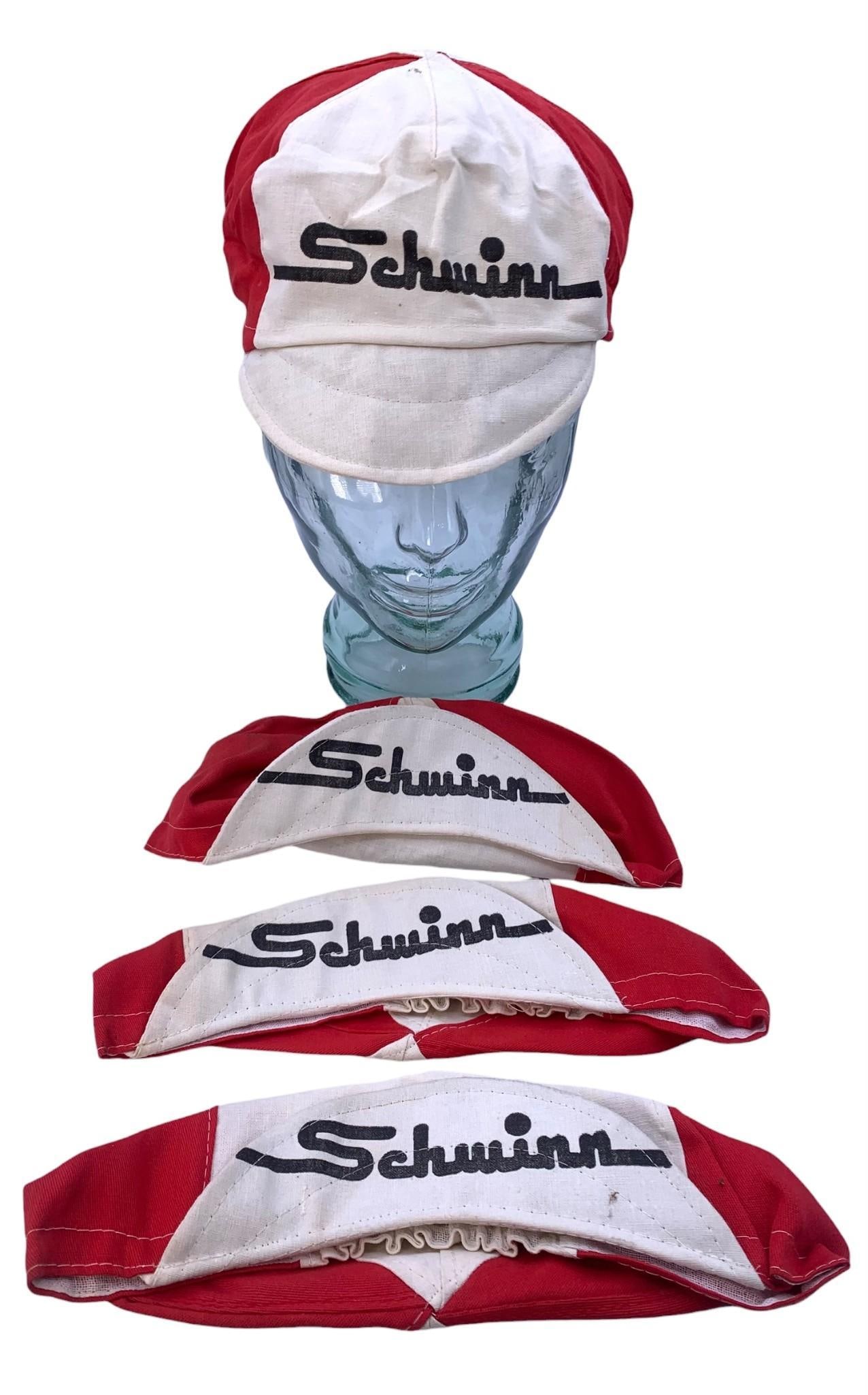 4 NOS Vintage Italian SCHWINN Bicycle Caps, Red & White Cycling Visor Hats: Each cap is stamped Made in Italy, Schwinn emblazoned on the crown, rear of the cap and under the brim, each in Unworn condition with folds to the fabric from decades in storage.