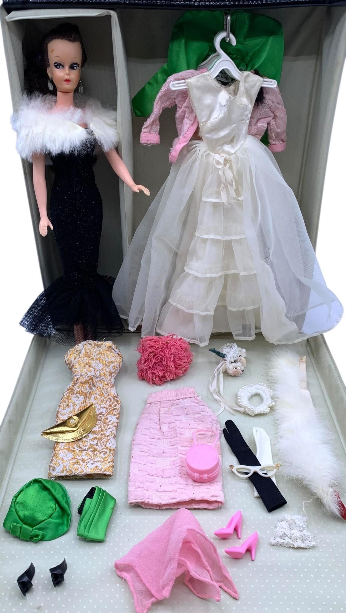 1961 Barbie Doll Case, Fashion Doll, Barbie Clothes & Accessories: Pieces shown included, patent vinyl Barbie case dated 1961 with minor age and wear to the exterior, Mid Century Barbie Imposter doll with LL mark on the nape, Barbie labels on the clothing. 