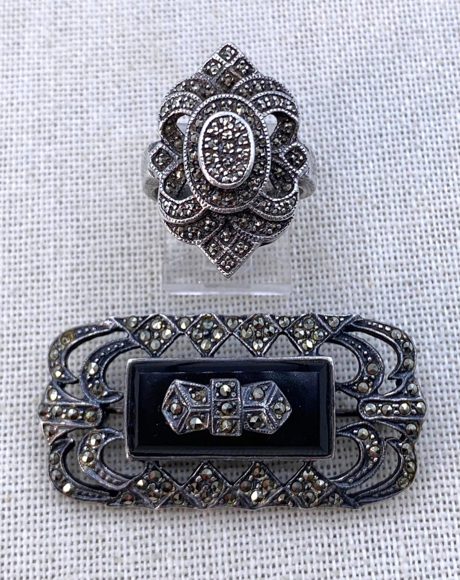 Sterling Silver, Sparkling Marcasite & Onyx Brooch & Dramatic Vintage Ring: 925 hallmarks on each piece, some warbling to the pin with functioning clasp, 1 7/8" x 1", 11.5 gram weight, size 7 ring, 8.8 gram weight, 1 1/8" along the finger, minor tarnish to the silver.