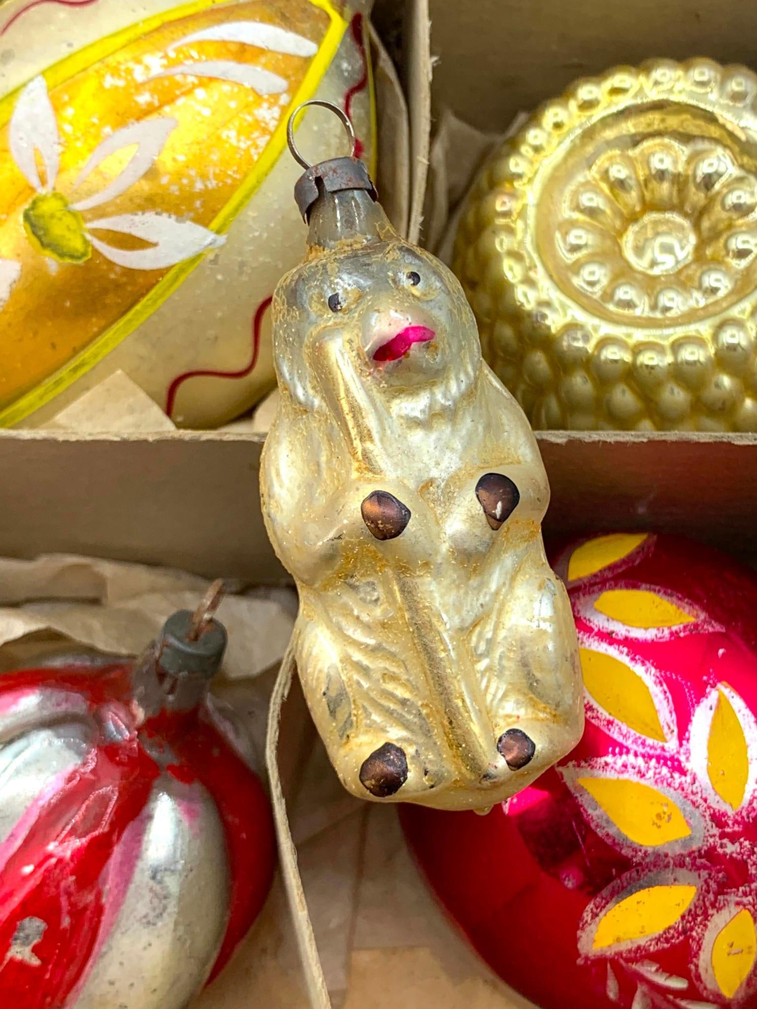 24 Antique to Vintage Mercury Glass Christmas Tree Ornaments in 2 Shiny Brite Boxes: Early German monkey, wire wrapped (has damage), hand painted, indent, grape, lantern and ribbed, one Mid Century dark cherry hard plastic double indent in the mix, 2 early Shiny Brite boxes included.