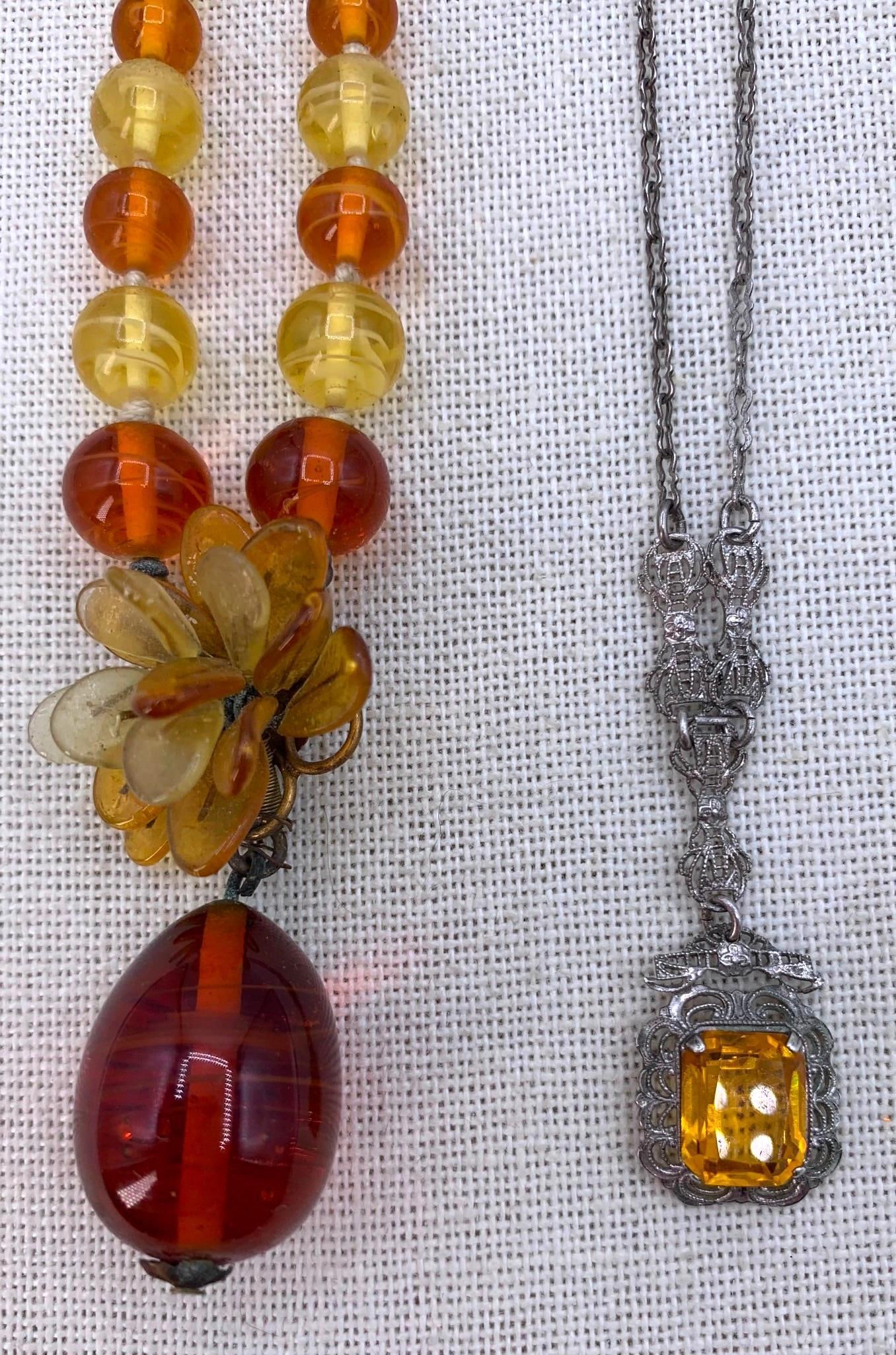 Two Antique c1920s Sterling Silver Filigree Citrine & Amber Glass Necklaces: 1) Hallmarked Sterling, ethereal openwork filigree, 10x8mm faceted Citrine hued Glass, 16" circumference, working pinch clasp2) Graduated amber hued glass bead necklace with wired leaf detail, han