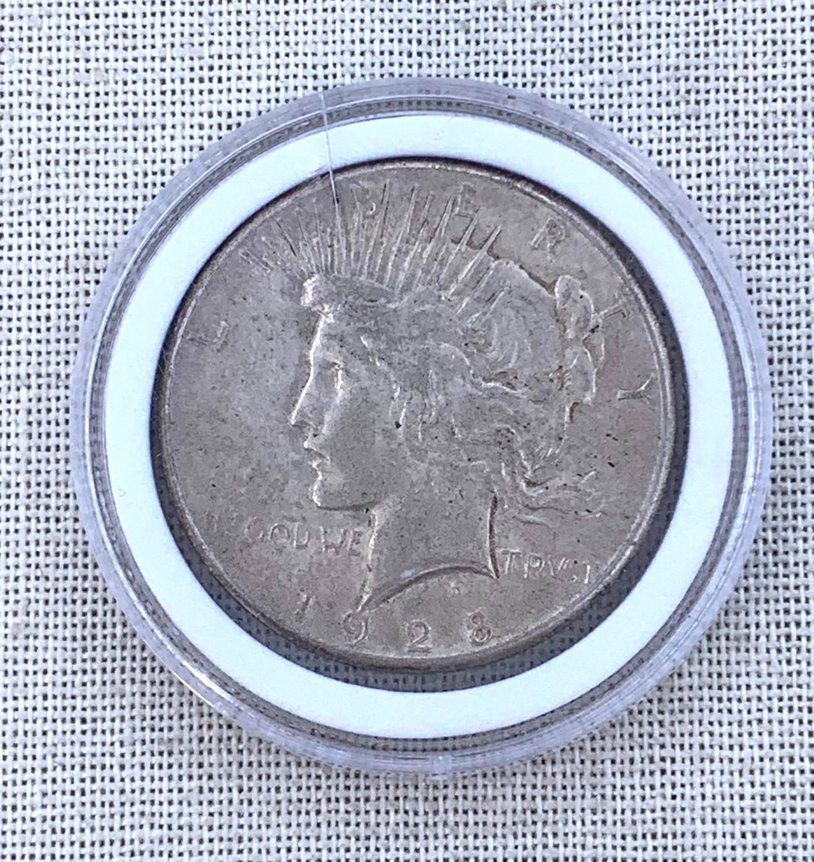 1928 Silver Peace Dollar $1 US Coin: Coin case has a hairline in the plastic, good definition to the coin.