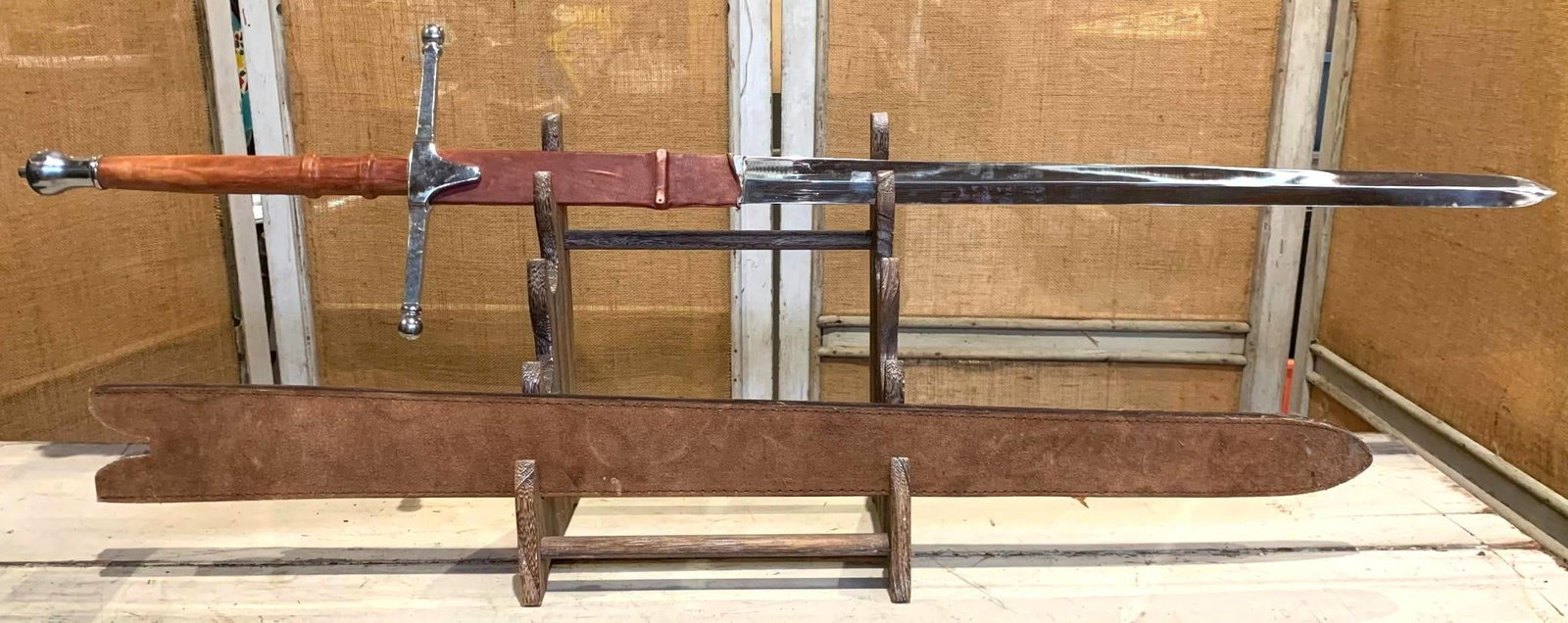 Impressive 50 inch Medieval Style William Wallace Scottish Claymore Sword with Suede Sheath: 50 3/4" total length, 11 5/8" metal guard with metal pommel, 40" leather sheath with back strap, hefty and well made with some wear to the leather.