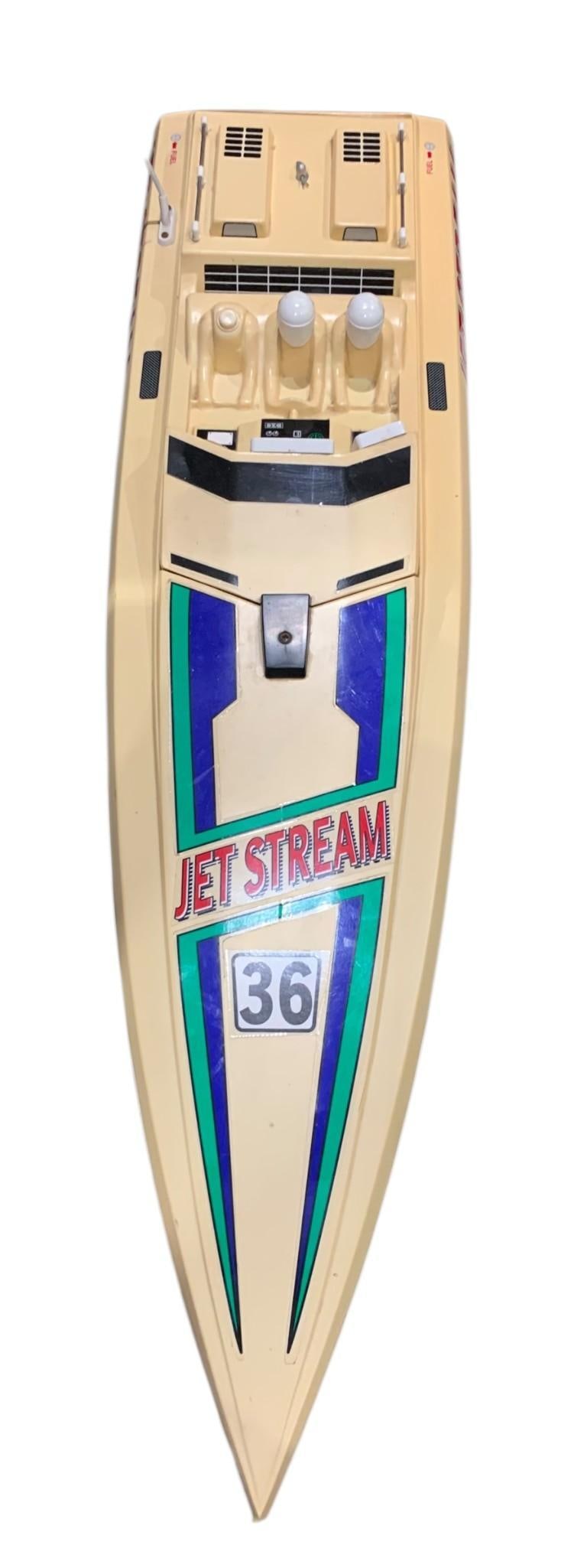 Vintage Kyosho Jet Stream 36 Radio Controlled RC Speed Boat Racing Toy: 33 1/2" total length x 8" width, one dash panel overlay and a figure absent from the interior, composite boat is structurally sound, Untested. 