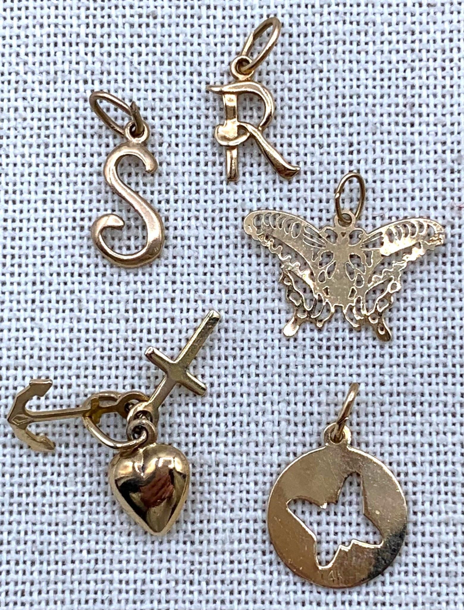 5 pc 14k & 10k Yellow Gold Charms: * 585 hallmark, anchor/heart/cross charm, .6 grams* 14k hallmark, R initial charm, .4 grams* 14k hallmark, S initial charm, .4 grams* 10k Tested cutout Butterfly silhouette charm, .6 grams* 10k Tested