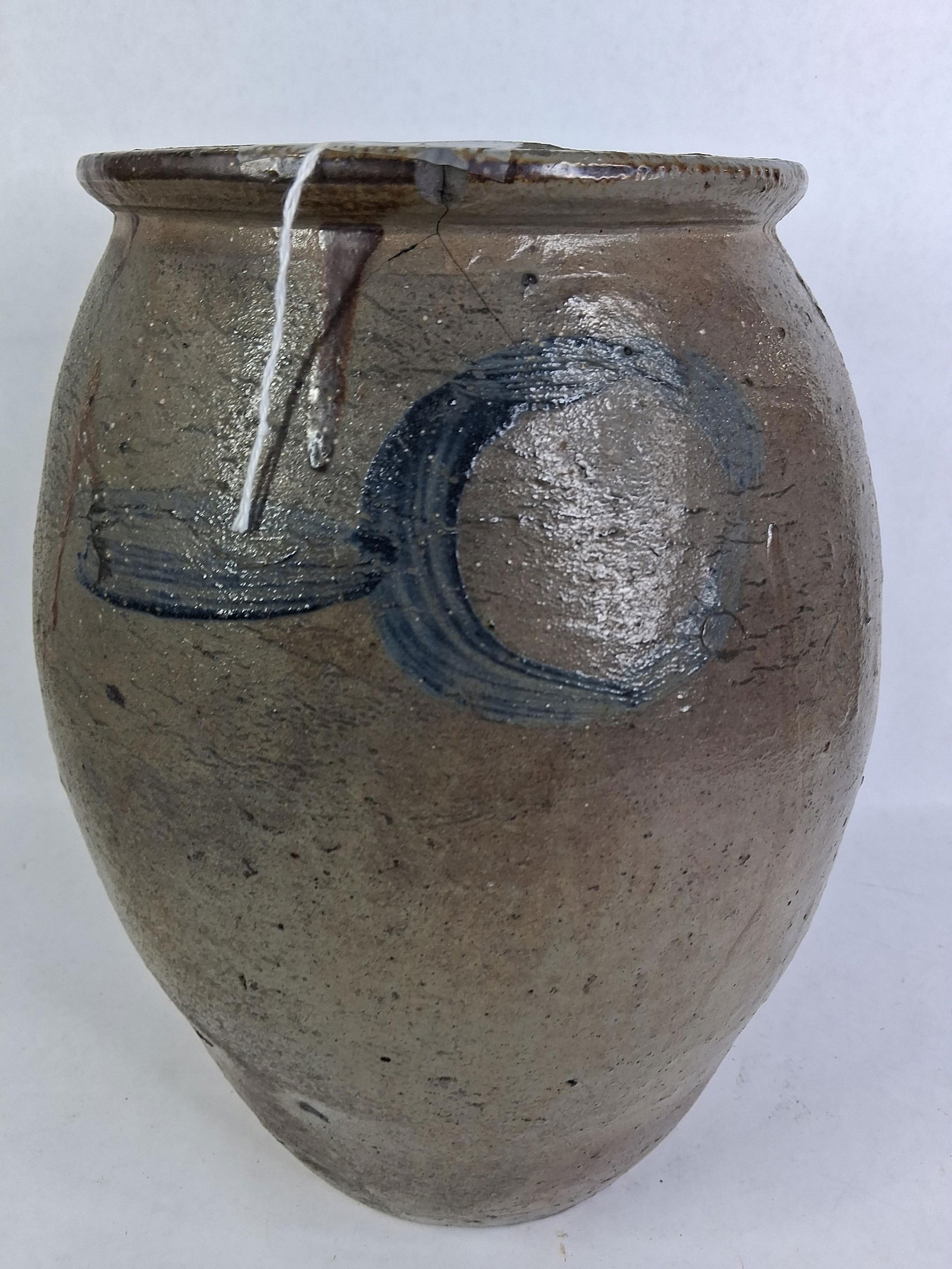 Cobalt Blue Decorated Stoneware Crock: Unusual circle and streak design. Approx 2 gallon. 12inches tall. Shows a hairline crack and chip from rim