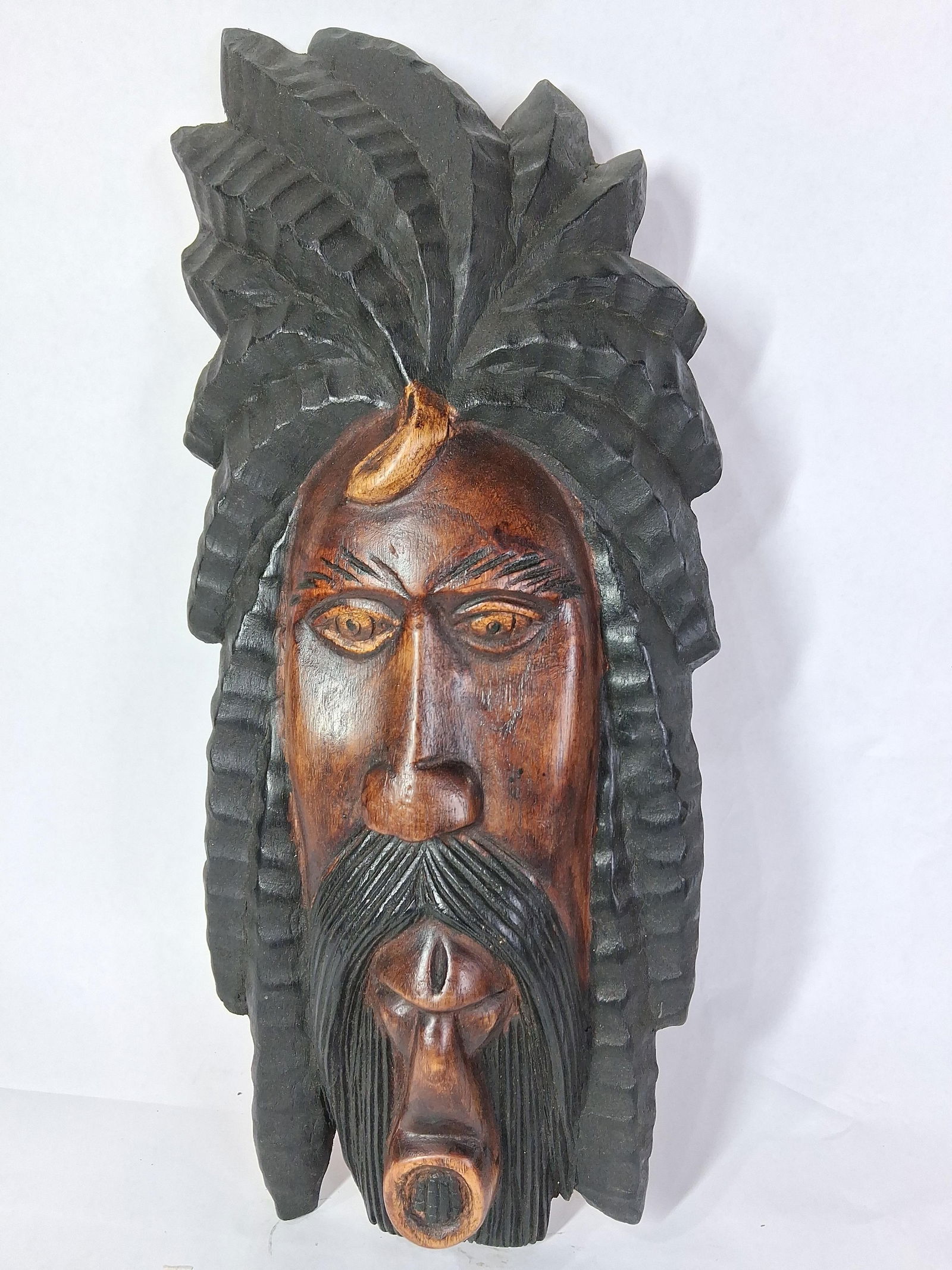 Hand Carved Jamaican Wood Portrait: Featuring intricate details, hair to represent dreadlocks, with a dark finish. 23x9