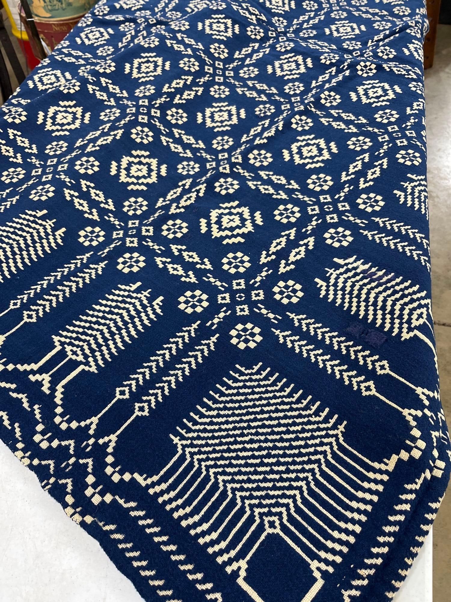 Cream and Blue Early Coverlet: A great primitive pattern. Does show a few small stains. Stitching through center looks great overall good condition. 67x 74