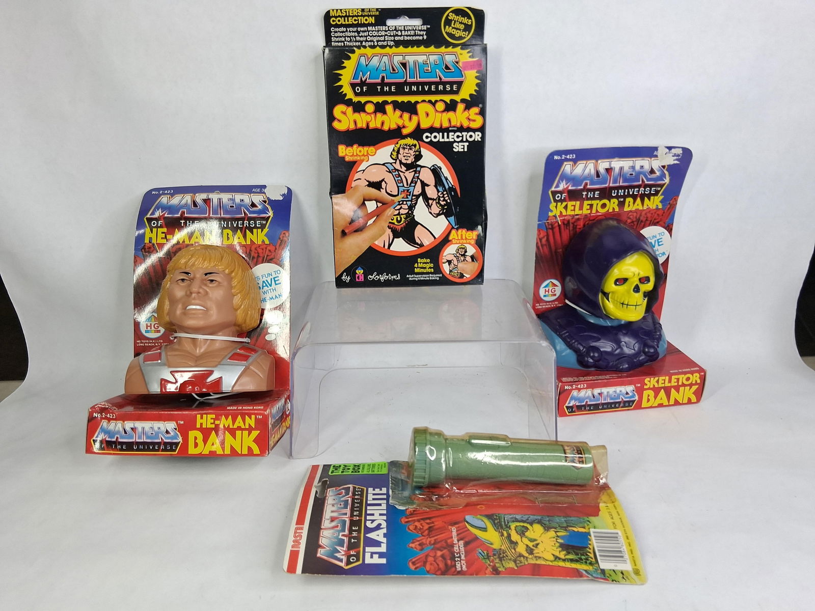 He-Man and Masters of the Universe Original Collectors Items: Skeletor and He-Man coin banks and flashlight. 1983 and 1984 toys. 