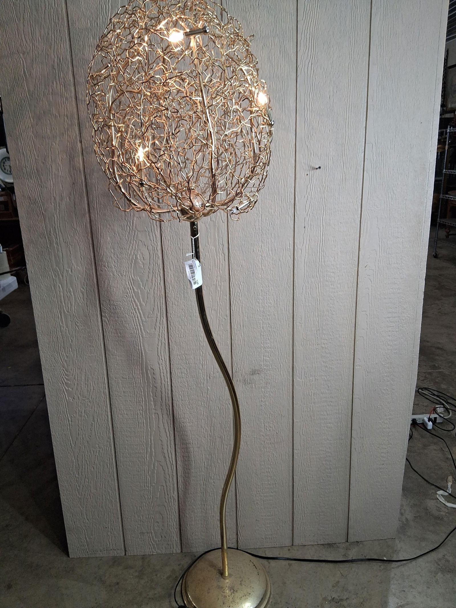 Hollywood Brand Van Egmond Style Floor Lamp in Gold: An iconic design with limb like structure and integrated lights. 67 inches tall with a curved stem and 15 inch diameter shade. Working condition. Minor spotting shows to base. 