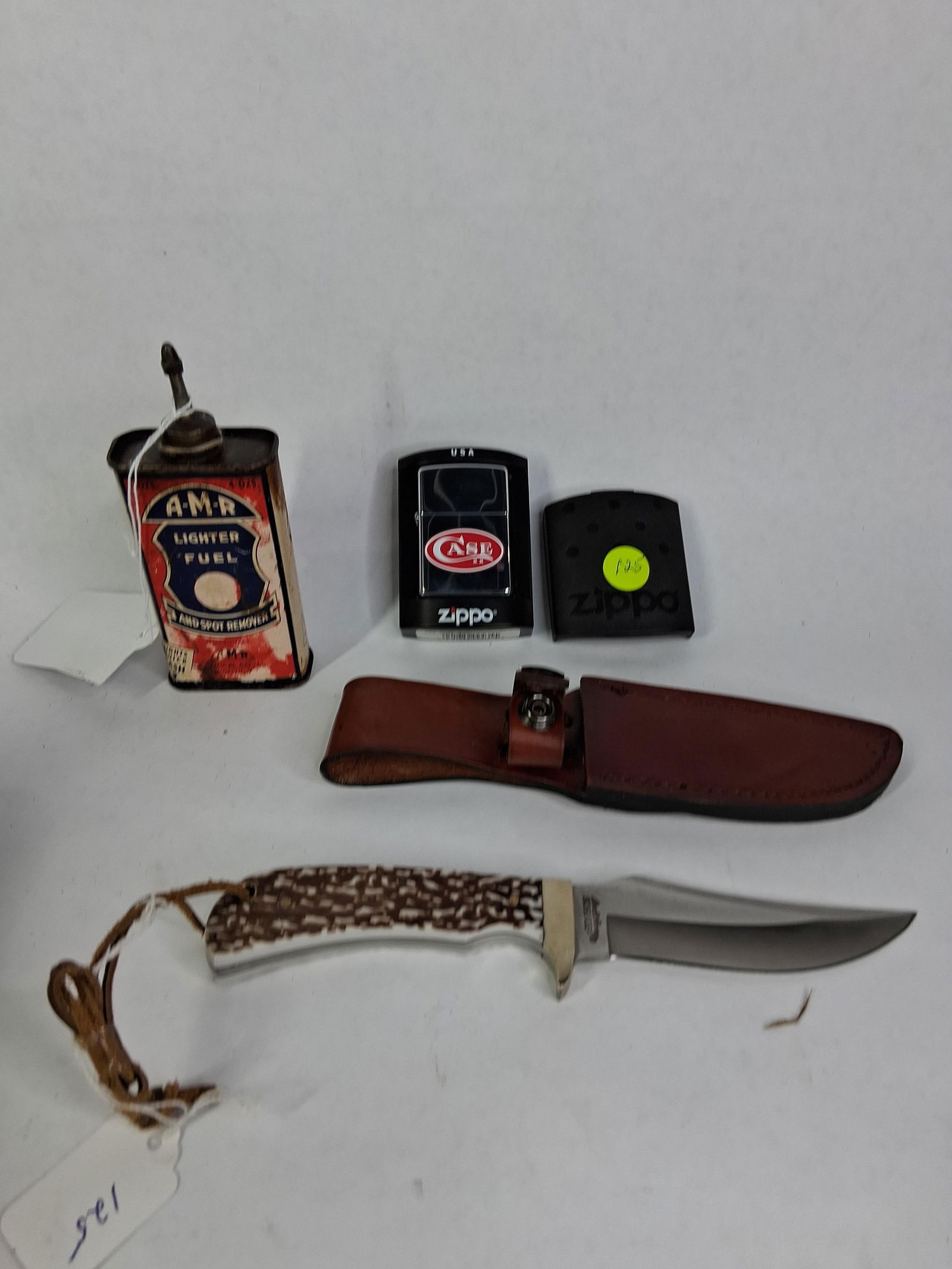 Case XX Zippo Lighter, AMR Lighter Fluid Tin & Schrade Fixed Blade Knife w/ Leather Sheath: Knife is like new, Zippo is like new in its original packaging and tin is showing wear and condition issues due to age and usage 