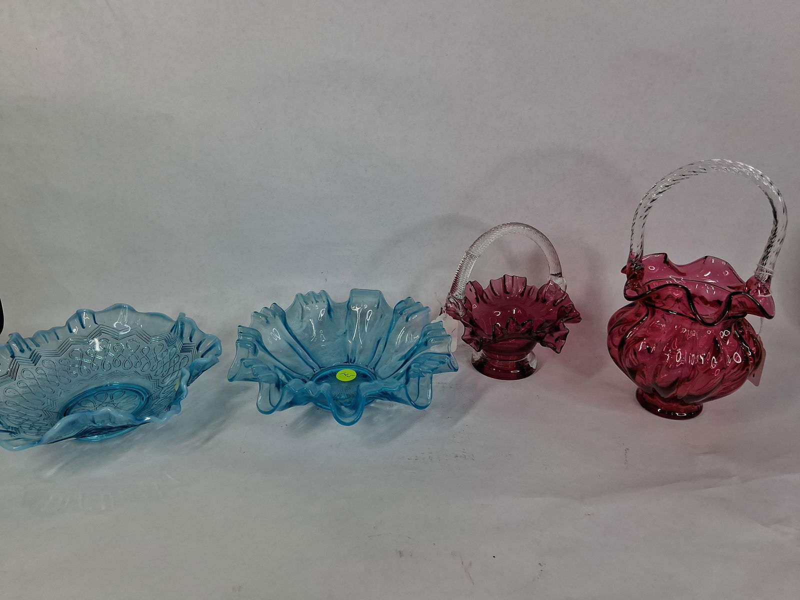 Dugan Opalescent Blue Ruffled Dishes & Fenton Cranberry Art Glass Baskets: This great lot of 4 pcs. shows no chips, cracks or breaks? Dugan ruffled dishes are 8 in. D Fenton Cranberry baskets are 6 and 8.5 in. H?