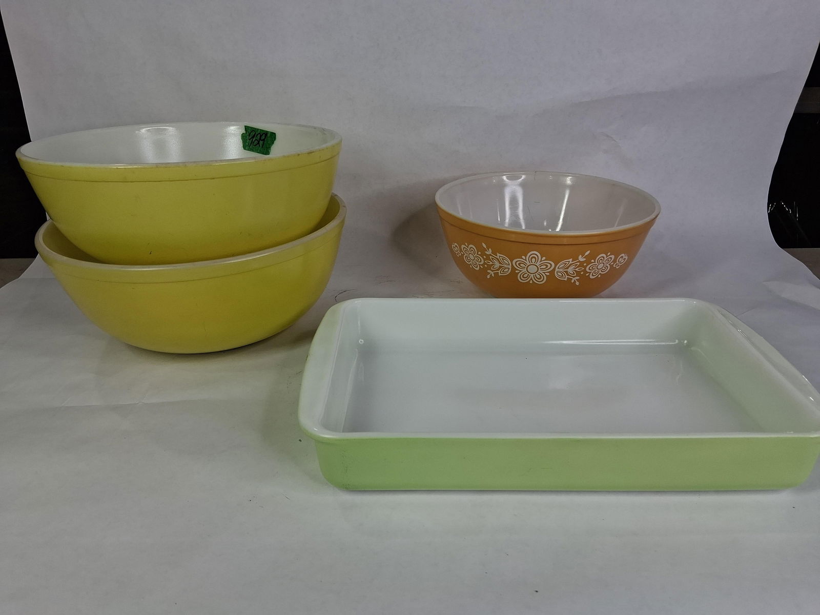 Pyrex Assorted Lot of Mixing Bowls and Casserole DIsh: This lot includes an orange 1.5 qt. mixing bowl with daisies, 2 canary yellow 4 qt. mixing bowls and lime green 2 qt. casserole dish none showing any chips, cracks or breaks 