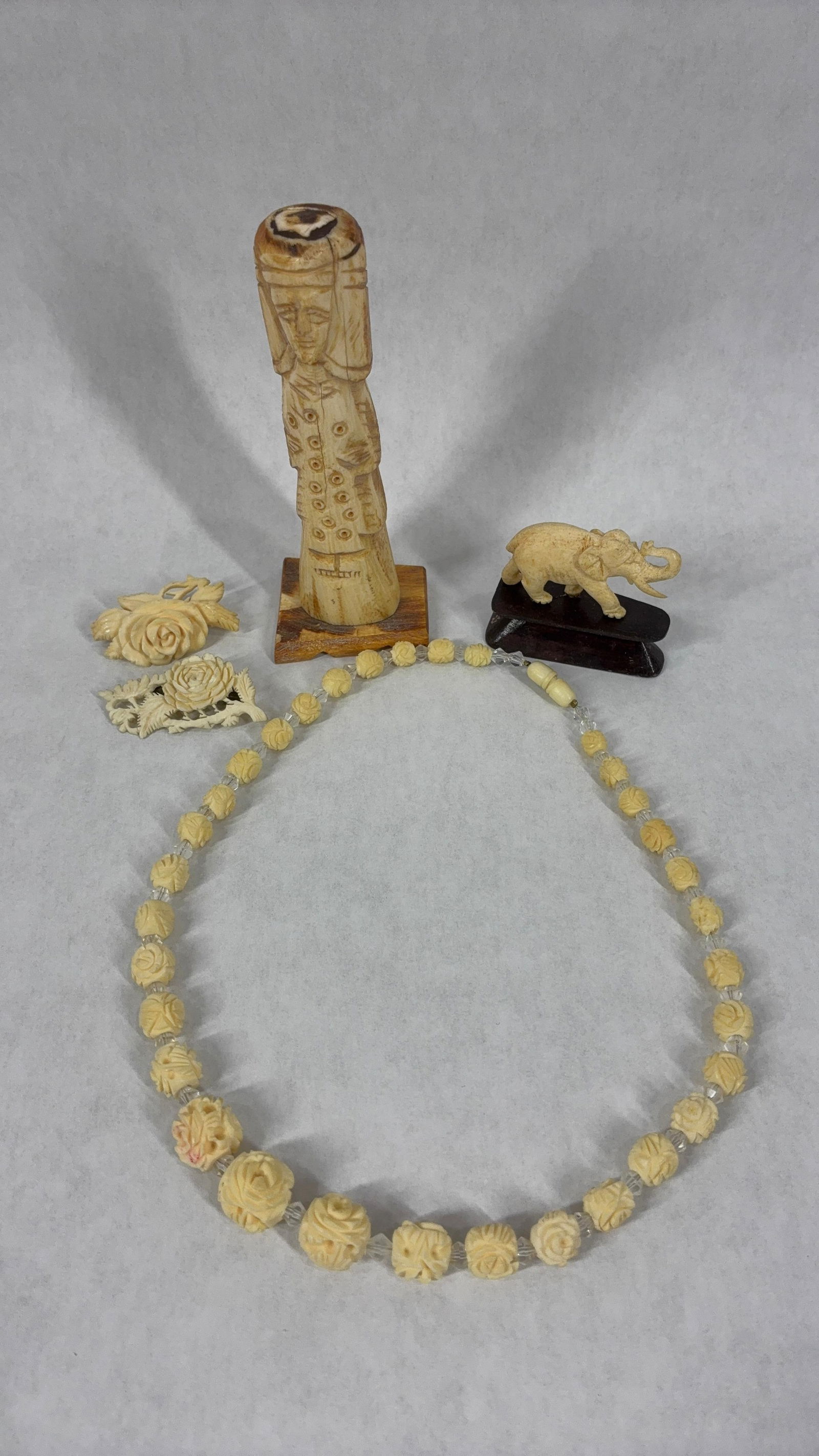 Hand Carved Wood Slavic Deity Figurine & All Natural Material Necklace, Pins and Bovine Elephant: This great lot of hand carved wood and all natural material figurines would make a great addition to any collection wood figurine 5 in. H with pins being 2.25 in. L, elephant is 2.25 in. L and