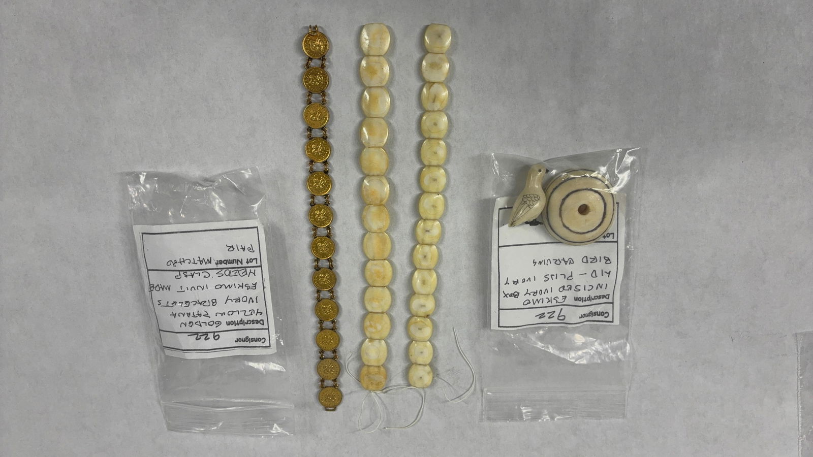 Inuit Made Bracelet & Carvings: Golden yellow patina tomatching pair of bracelets. One needs clasp repair. Little bird measures 1.5 inches and the other is possibly a lid of some kind. All pieces are carved from a natural material.