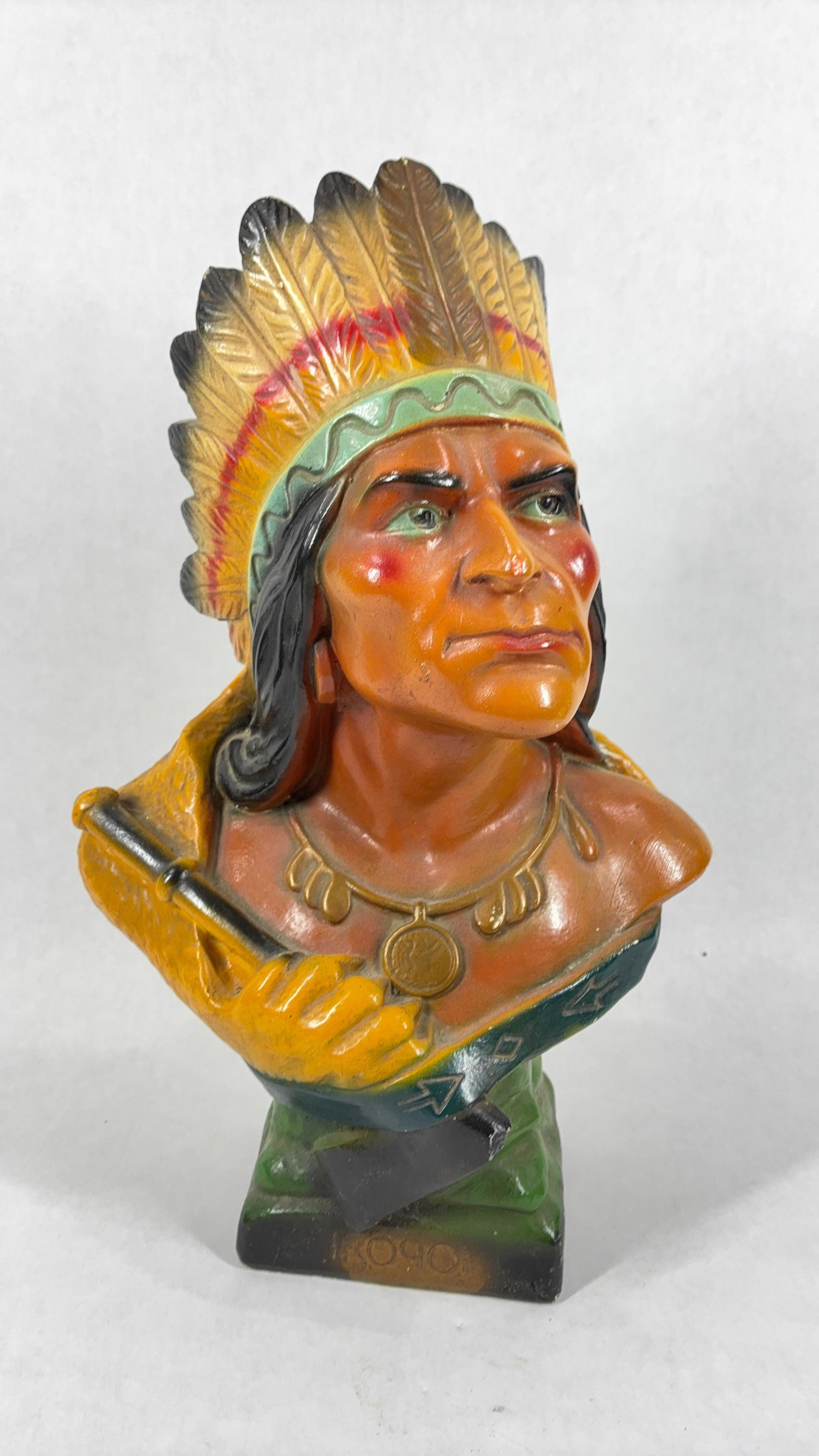 Chalkware Iroqi Native American Chief: Iroqi stamped to front with vibrant color. A small chip to the top of feathers and tip of nose. 15 inches tall