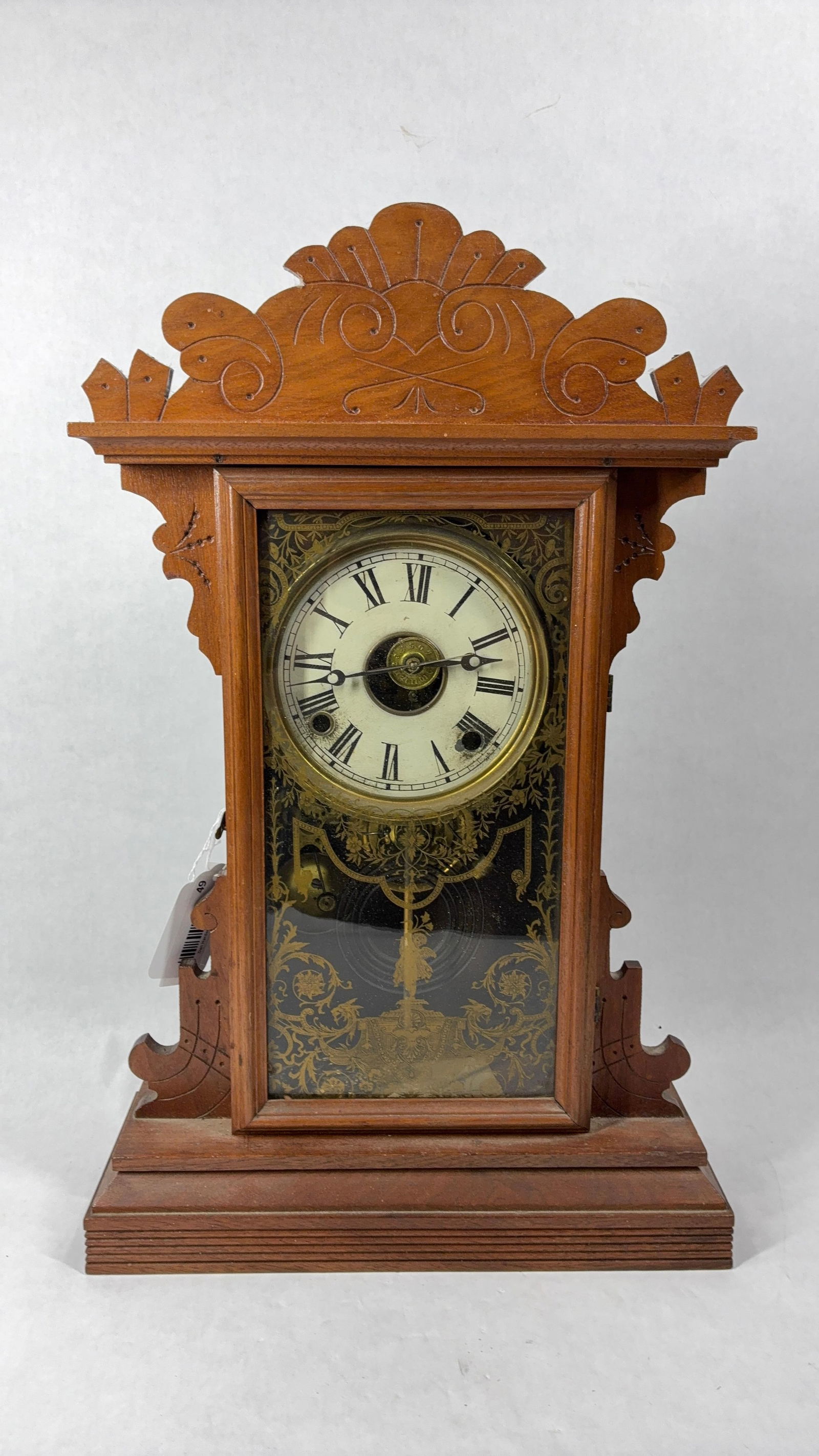 Key WInd Oak Gingerbread Mantle Clock: Clock will need some repair to hands, includes pendulum, and key. Chimes on every half hour. Intricate cherub and scroll work to front glass panel. 21x13