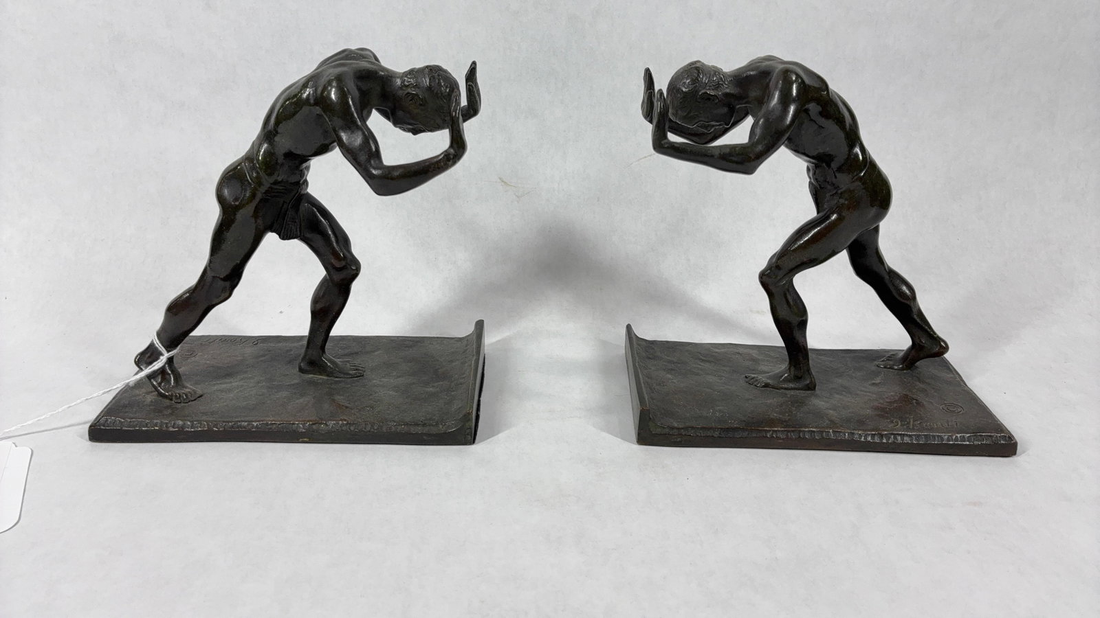 Kontis Pushing Men Bronze Bookends: Artist signed, each is 6.5x6.5