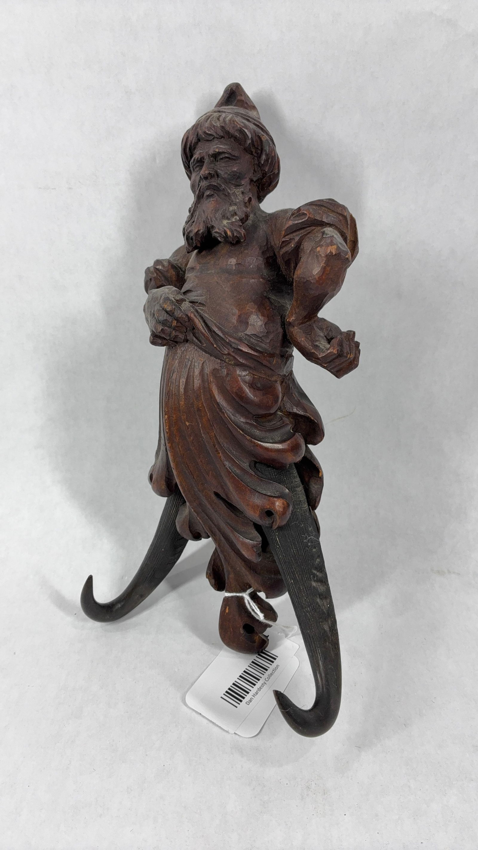 Black Forest Carved Genie Whip Hook: A hand carved magical genie with turban and draped clothing. Sitting a top a pair of horns, a wonderful old folk art piece. 12 inches
