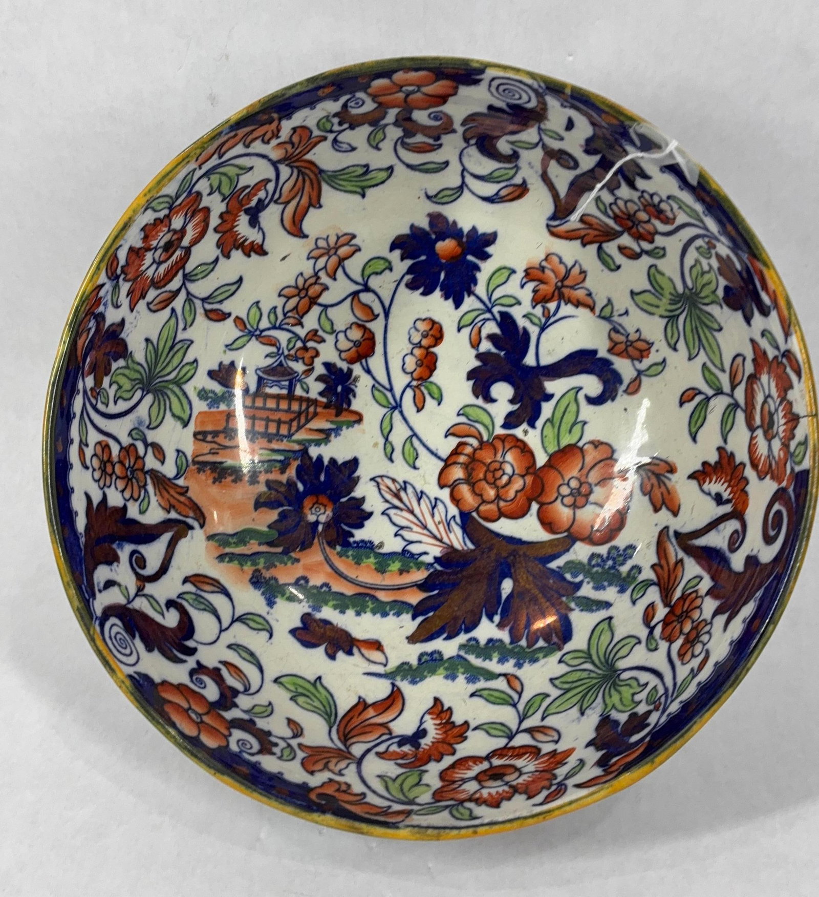 Ca 1895 Large Amherst Japan Fruit Bowl: A bold pattern with orange and cobalt floral design. A small crack is shown to the rim being from the kiln and not damage. Base has been removed as seen in photos. 10.5 inches in diameter
