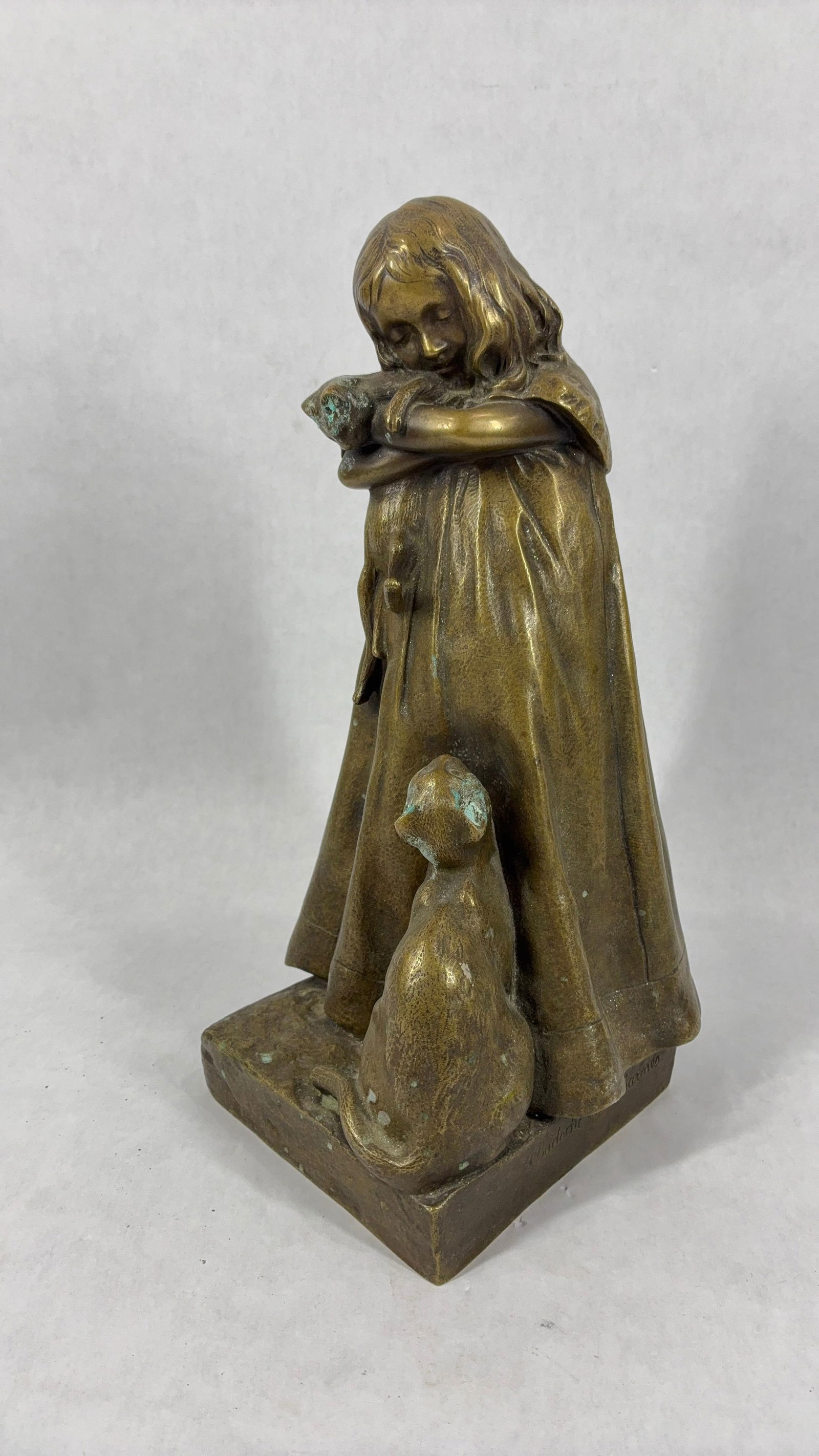 A Girl with Two Cats Bronze Figure: Signed Badoche Descharnes French artist. Some patina shows to cats head. 12 inches tall.