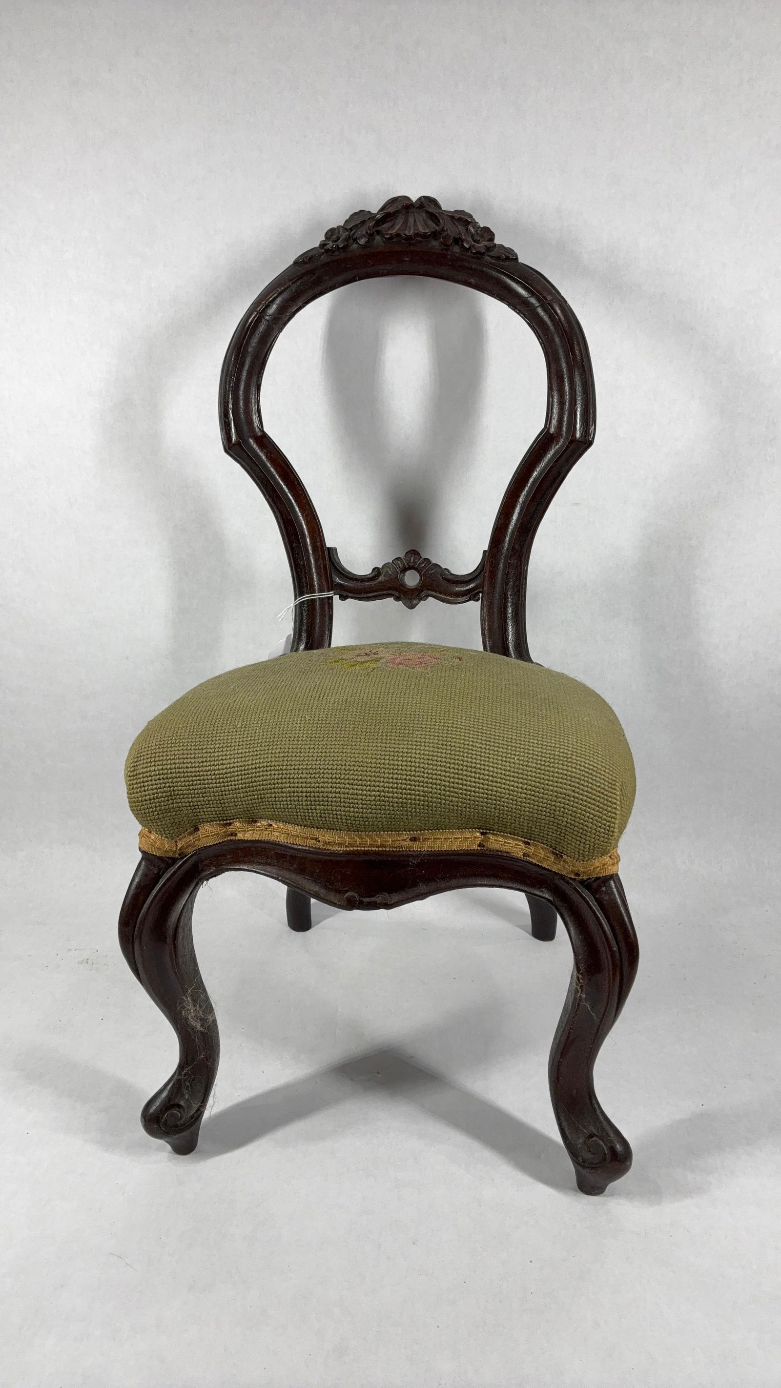 Victorian Balloon Back Childs Chair: WIth a needlework seat and dark hardwood body. Hairlines show to the back rest. 24 inches tall
