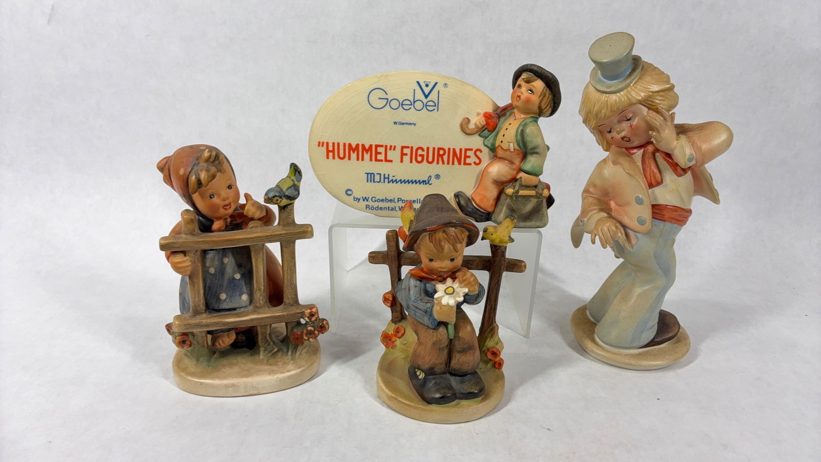 Goebel Hummel Figurines: West German Made. Includes Hummel plaque 1947, She loves Me Signs of Spring, and Opps 1986. Opps has a repaired finger.