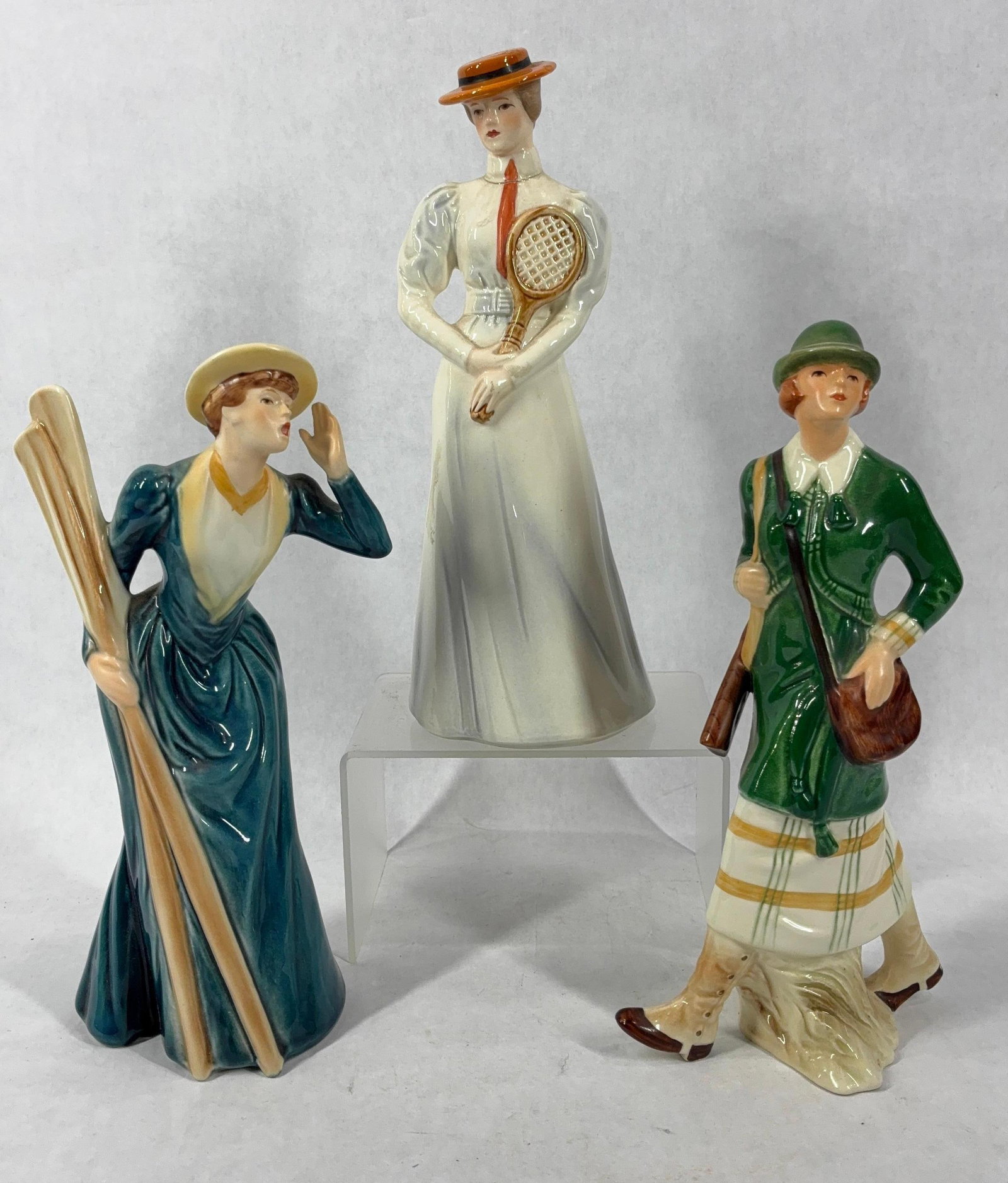 Goebel Sports Lady Victorian Figurines: Including Center Court 1903, To The Hunt 1913, and River Outing 1889. Each is in good condition with no chips or cracks. 8.5 to 9 inches tall