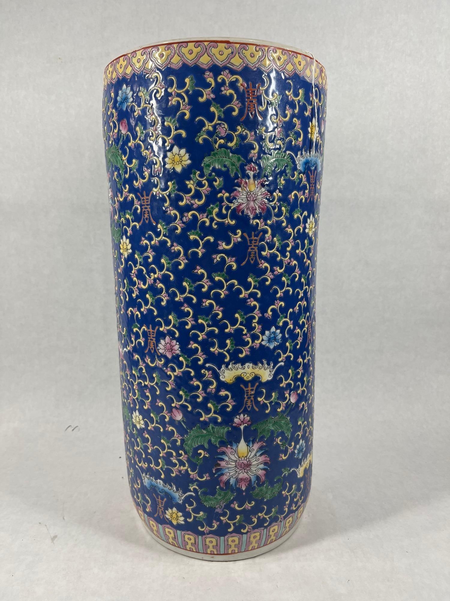 20th Century Chinese Porcelain Umbrella Stand: vibrant cobalt blue and hand painted floral designs. Bottom is stamped. No chips or cracks found. 18x8.5