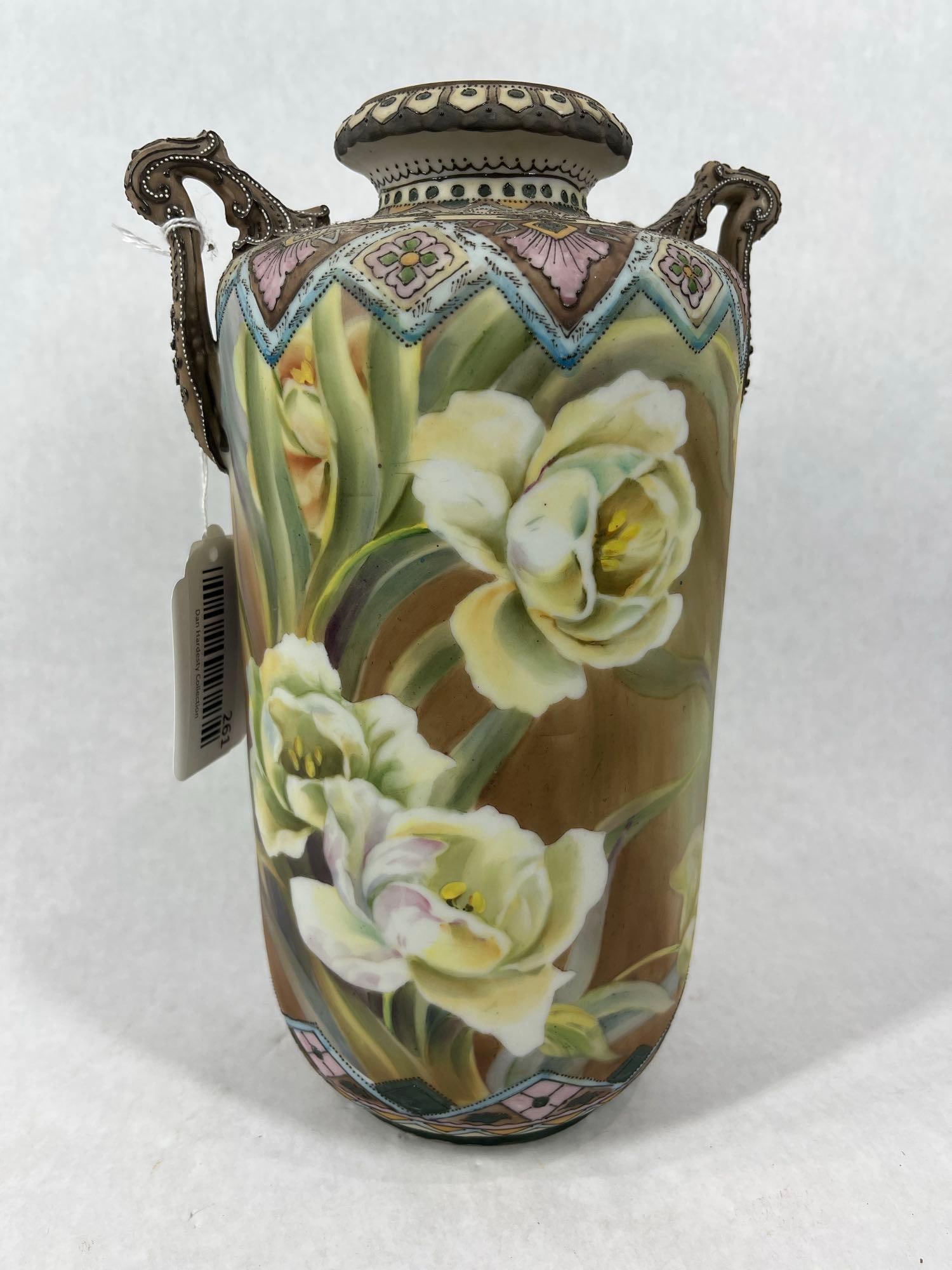 Two Handled Aztec Floral Vase: An array of patterns from cream colored flowers to the pattern around the base and rim. Excellent condition. 11x5