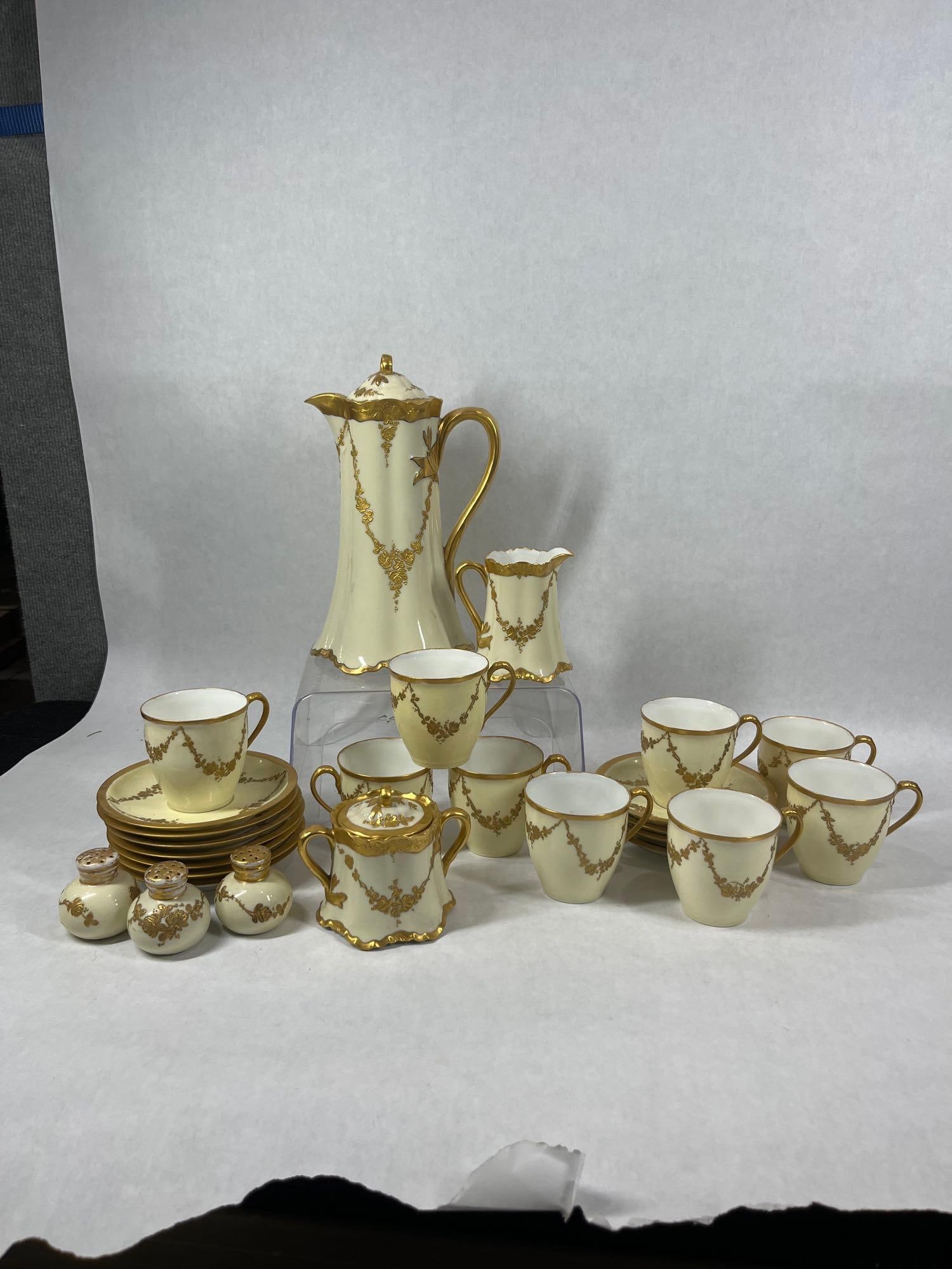 French Haviland & Co Limoges Tea Set: Including Pitcher with lid, creamer, sigar, 3 shakers, 9 mugs, and 11 saucers. Pitcher shows a hairline crack but the rest has no large chips or cracks but each piece was not thoroughly inspected for