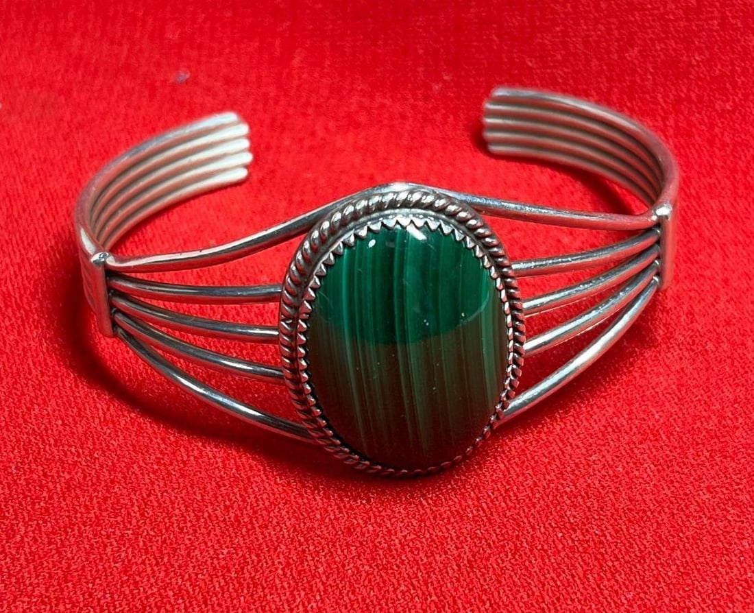 Malachite Sterling Cuff Bracelet: Large 1 inx.75 in green stone. Marked sterling. 2.25 in diameter. 23.9 grams
