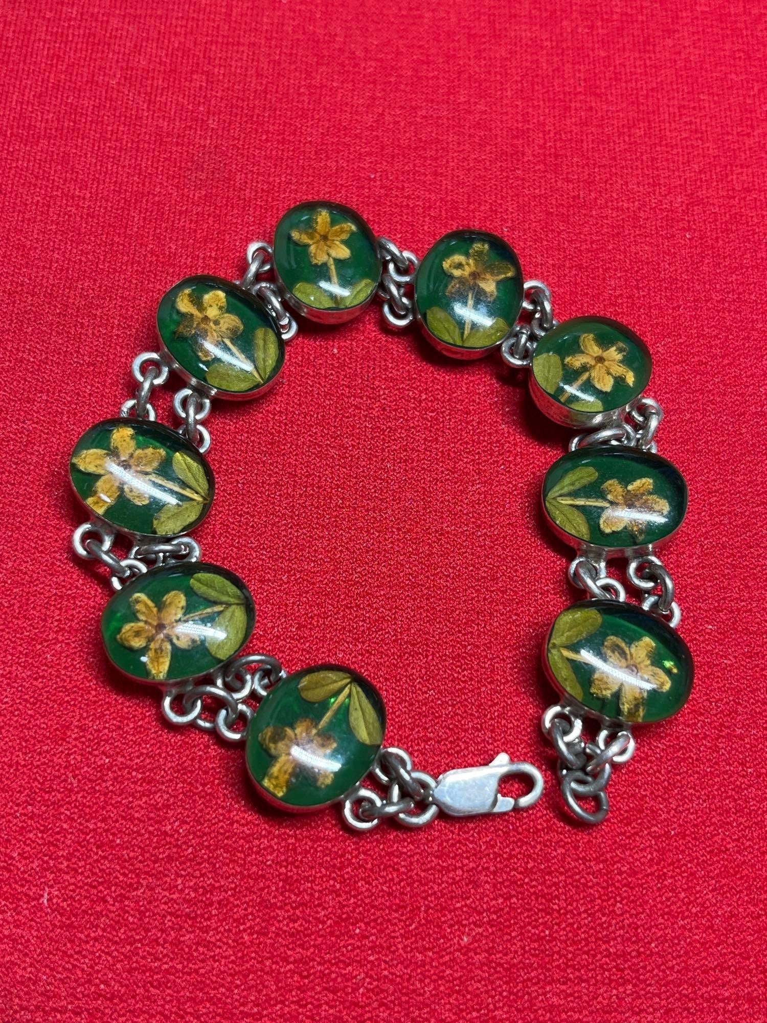 Daffodil Resin Sterling Panel Bracelet: 9 floral panels each ajoned with sterling chain. 7 inches .