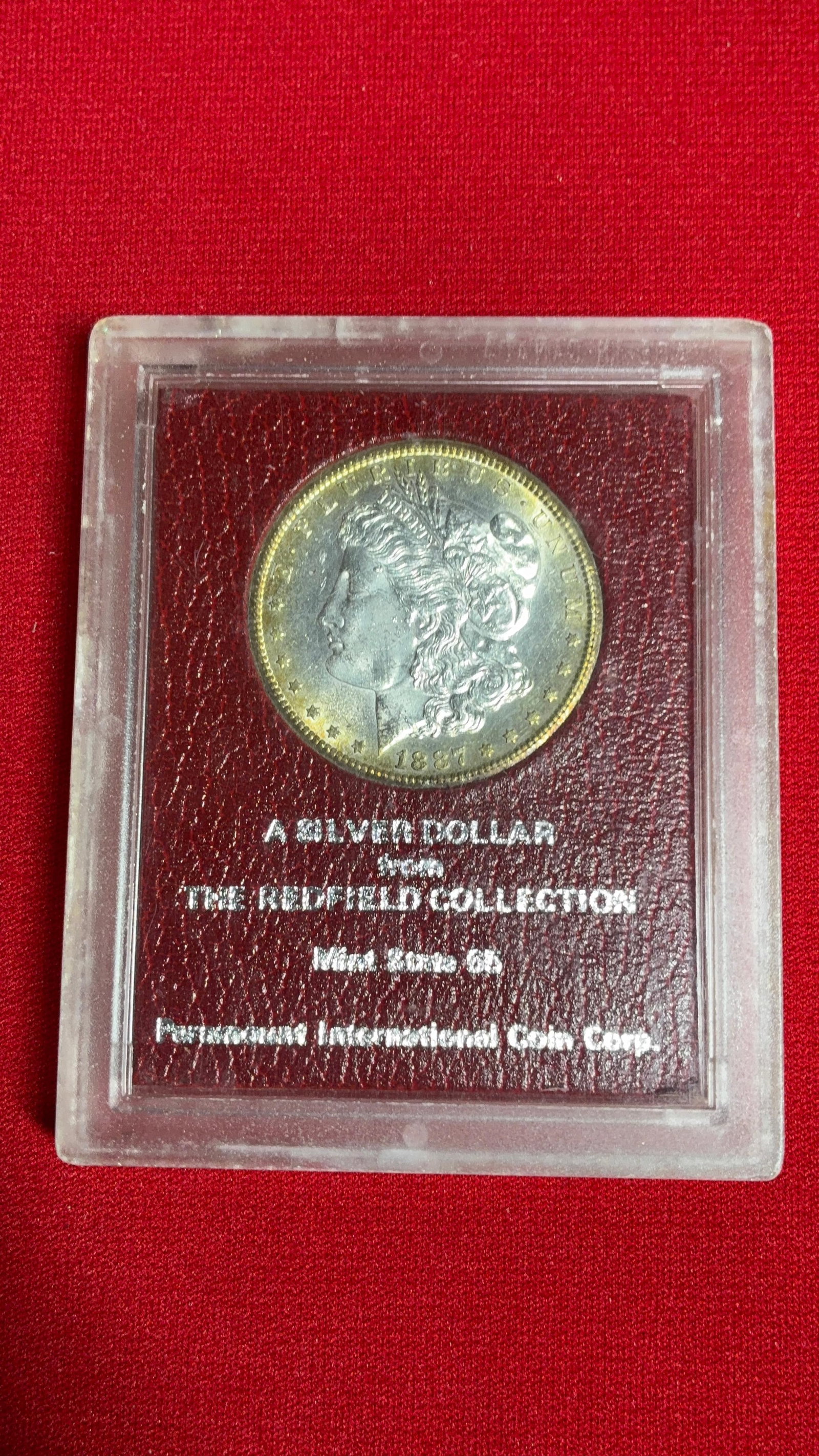 1887 S Morgan Silver Dollar: MS 65 Red field collection. Toned around edges