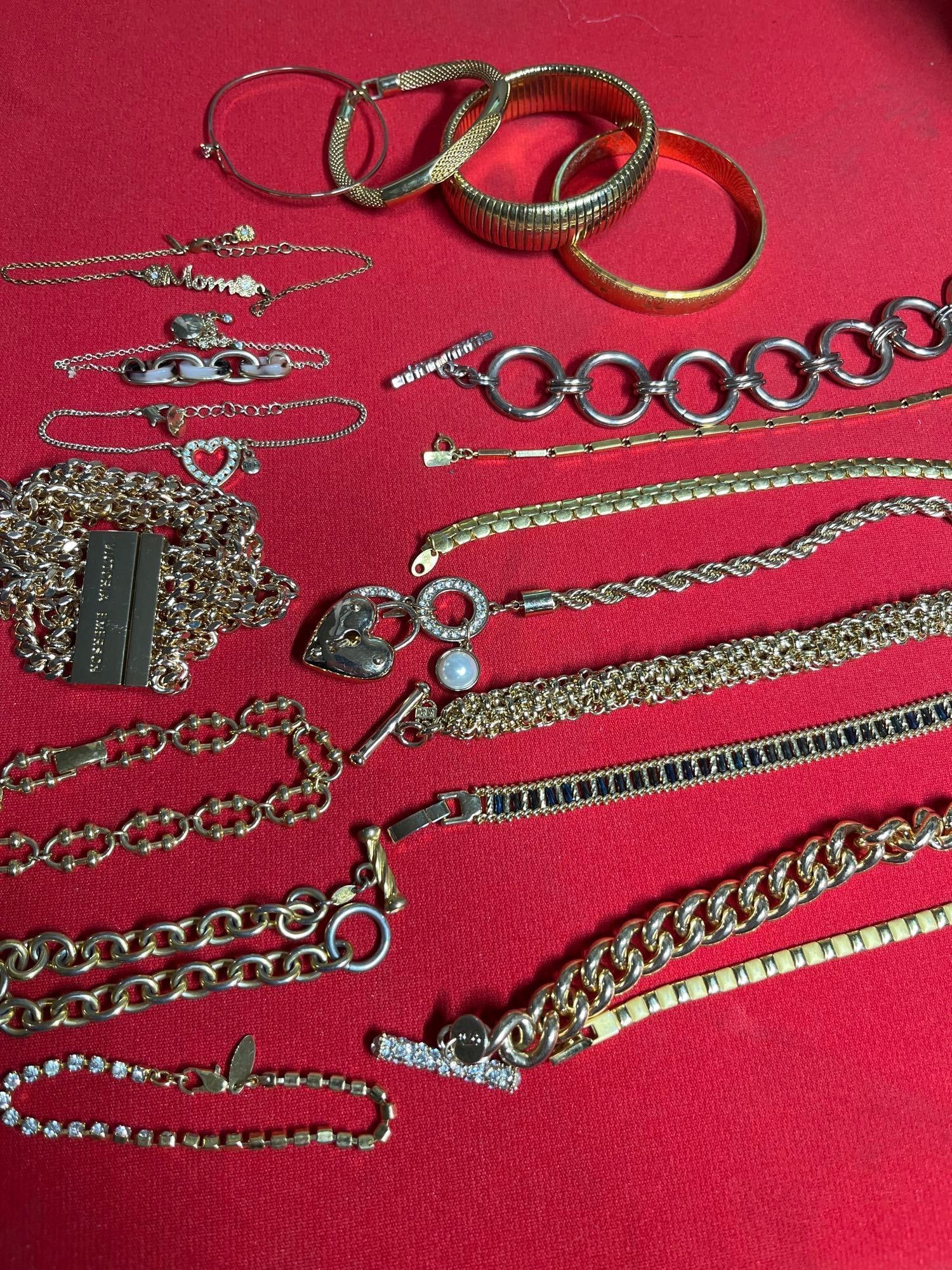 Monet, Victoria Secret, Napier, Sarah Cov, Guess, and Other Designer Gold Toned Bracelets: A very nice grouping of gold toned bracelets.