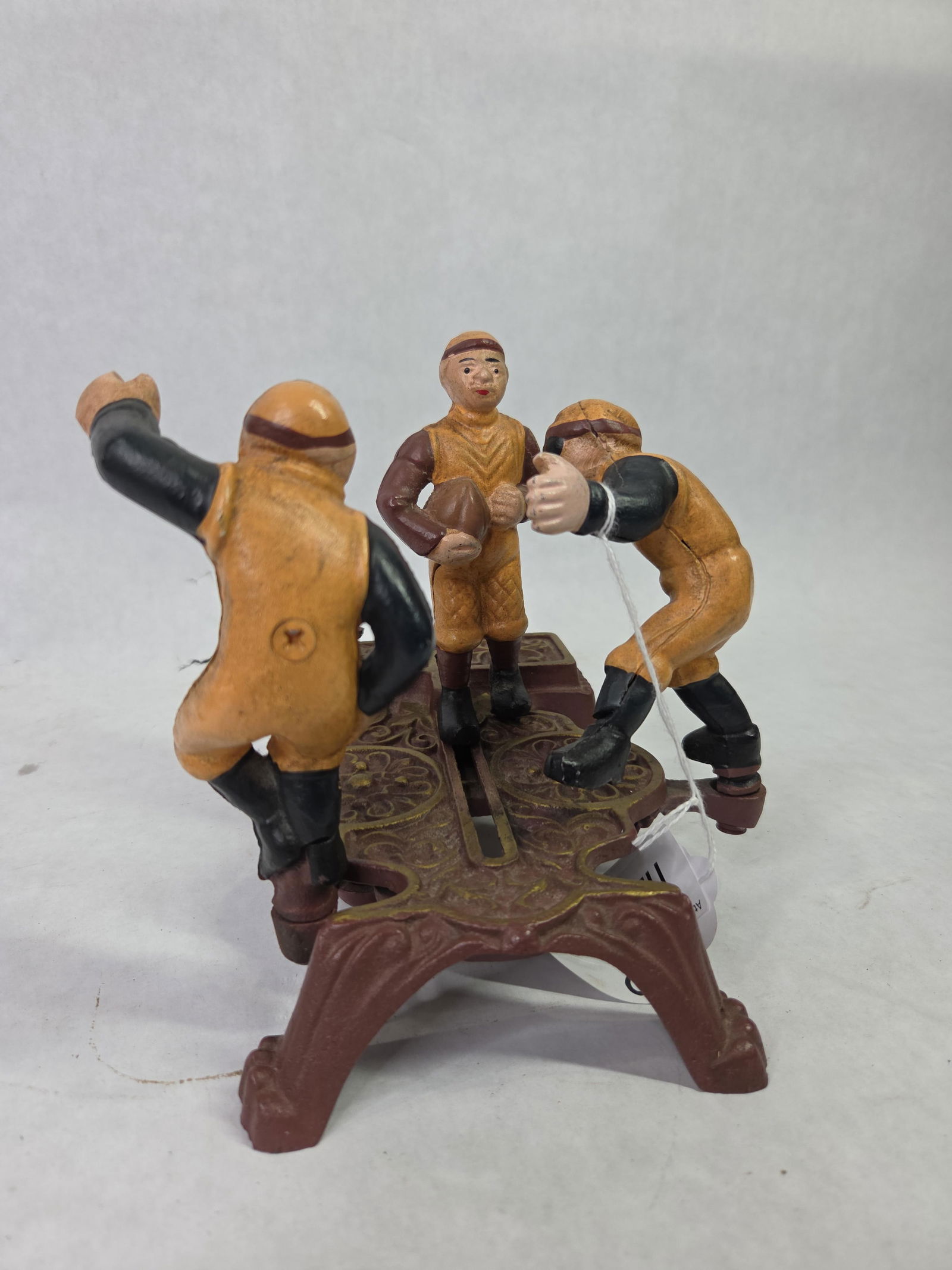 Cast Iron Painted Calamity / Football Mechanical Coin Bank: Good overall condition standing 6.5 in. H