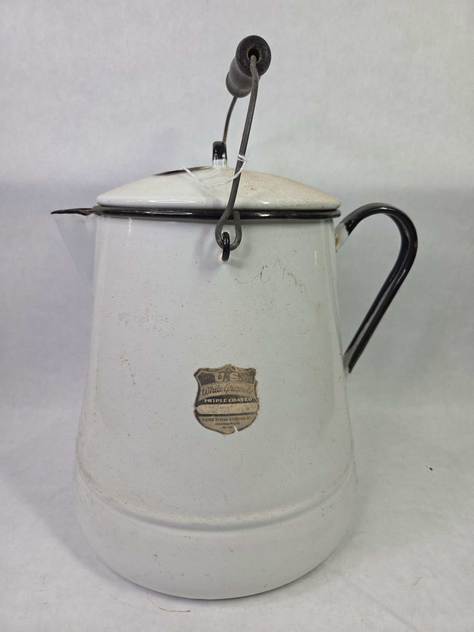 U.S. White Granite Lidded and Handled Enamel Water Pot w/ Original Label: Great condition with bale handle fully intact as well standing 12 in. H with a diameter of 10