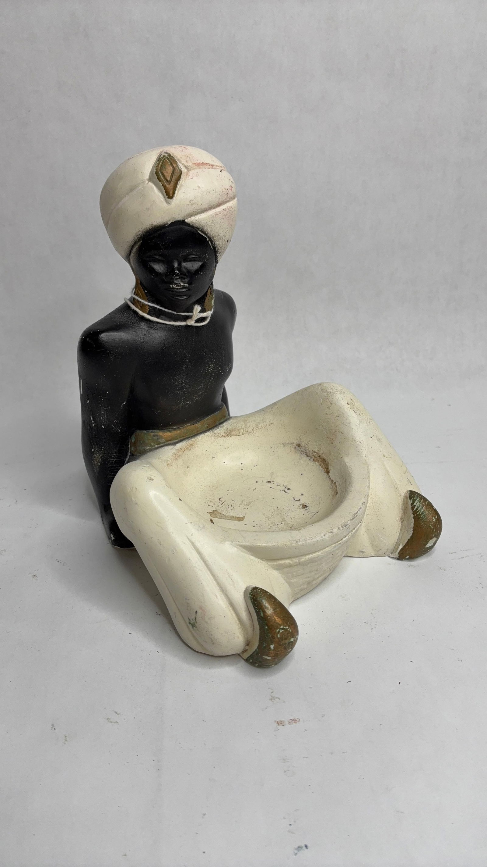 Mid Century Blackamoor Nubian Chalkware Genie Trinket Dish: Great early condition showing minor areas of flaking to paint as well as flea bites standing 8
