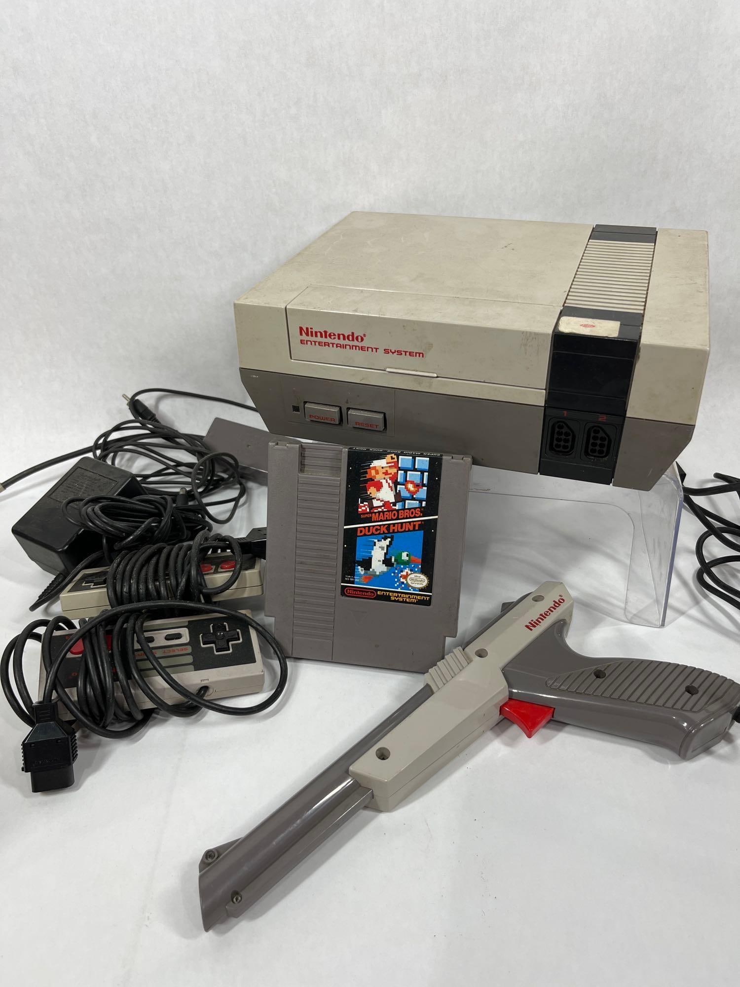 Original NES Nintendo Game Console System w/ Gun, Controllers and Mario/Duck Hunt Game: This great vintage gaming system lot includes power cord, console, controllers, Mario / Duck Hunt and Shooting Gun this system is untested but appears to be complete