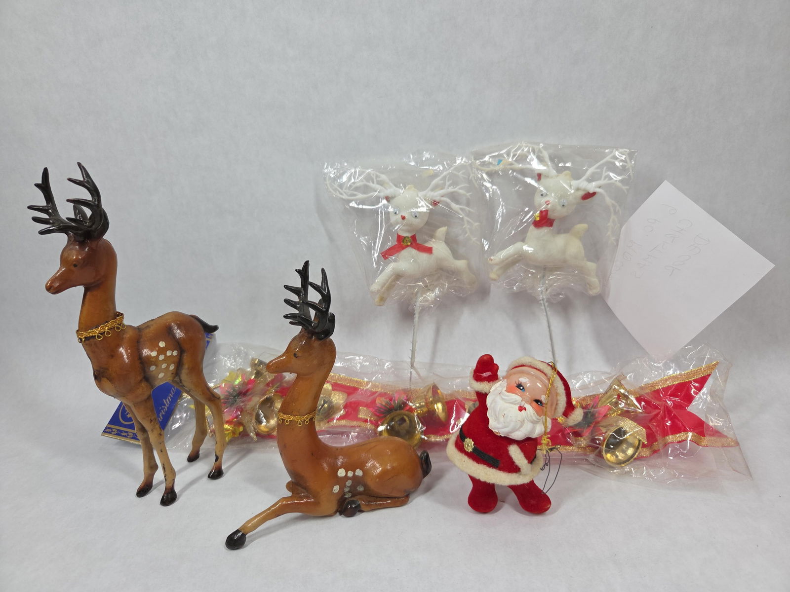 Mid Century Holiday Decor Inc. Celluloid Reindeer, Flocked Santa and More: This great mcm christmas decor lot includes 6 assorted holiday items including deer, santa and NOS ribbon w/ bells all in great or new condition