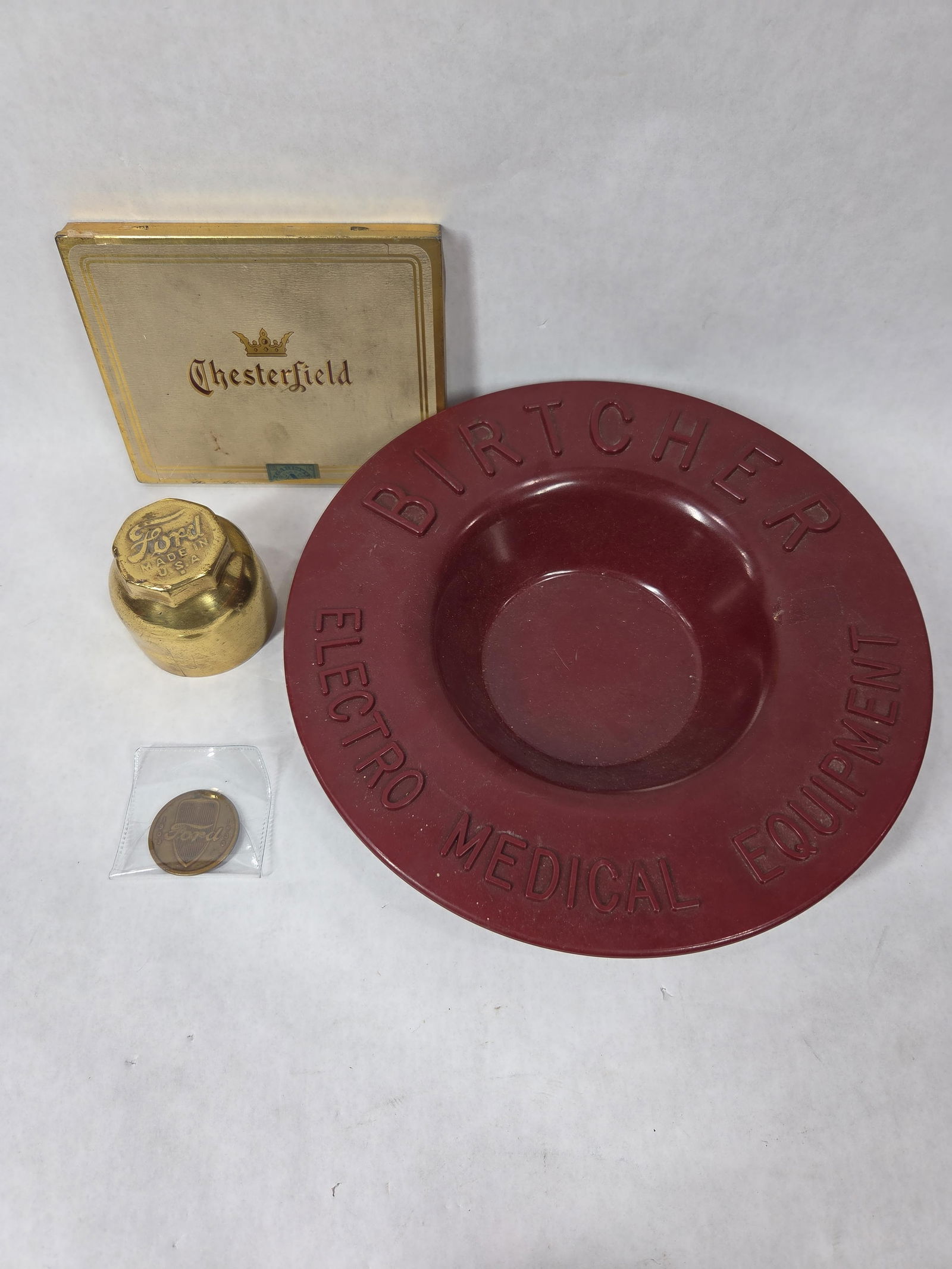 Birtcher Medical Equipment Tool Rest, Ford Center Cap, Ford Commemorative Coin and Tin: Great commemorative lot including medical bowl, center cap, coin and chesterfield cigarette tin