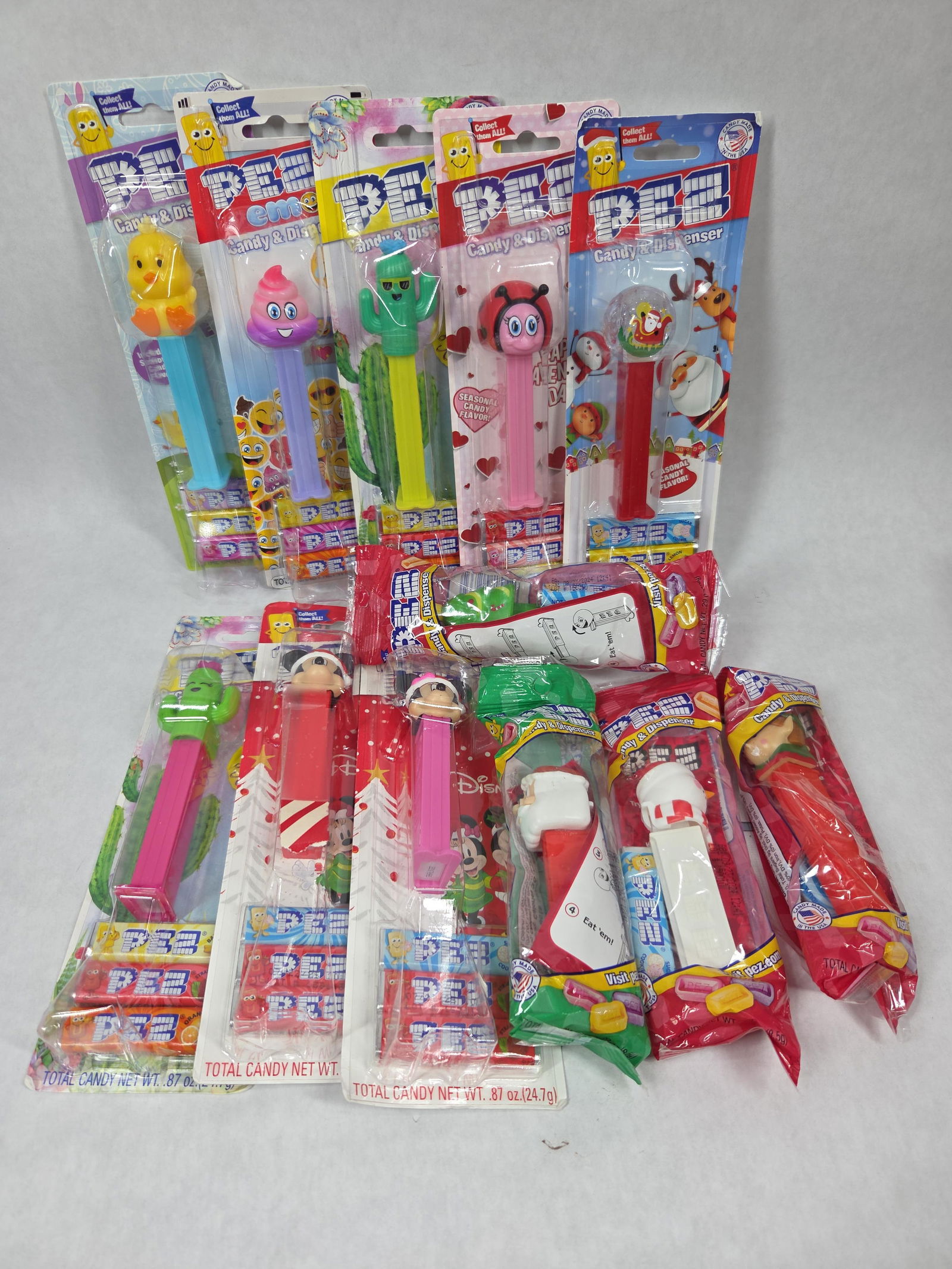 NOS Pez Dispenser Lot Inc. Mickey Mouse, Minnie Mouse, Easter, Cacti and More: This great NOS lot of unopened dispensers including candy are great sealed collectible items and includes 12 assorted dispensers all sealed