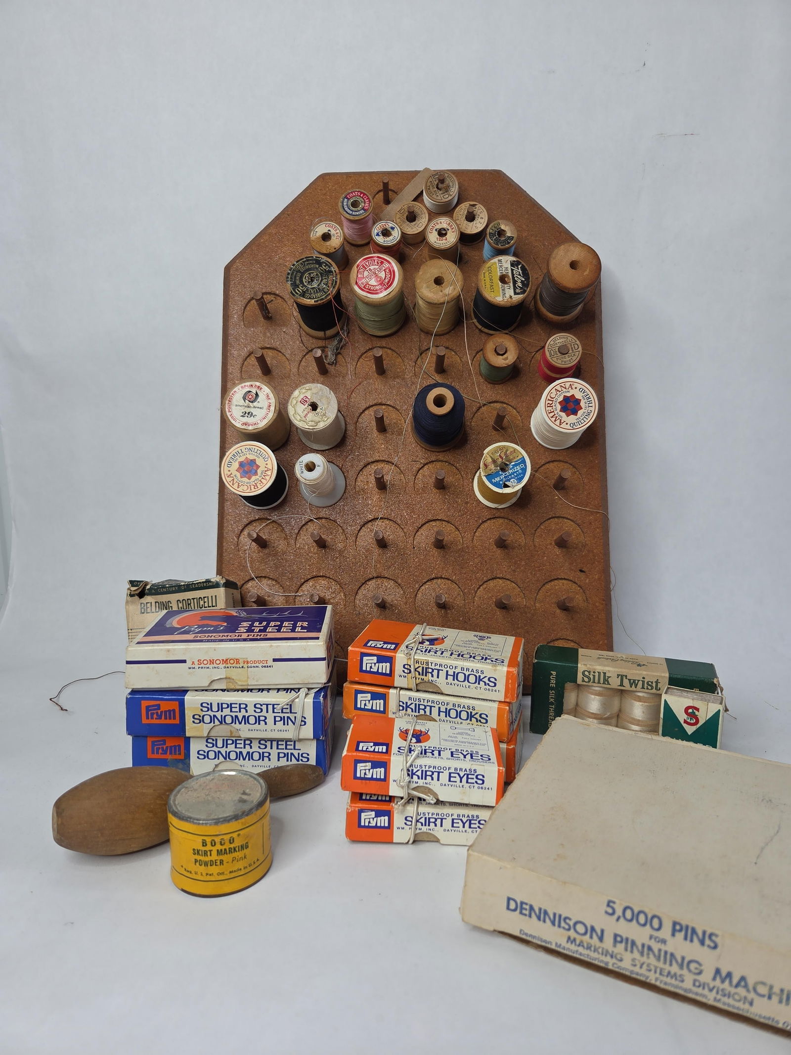 Vtg sewing lot: Includes new old stock prym skirt hooks and eyes ,sonomor pons boco skirt marking powder ,wooden thread spools and wooden thread holder board