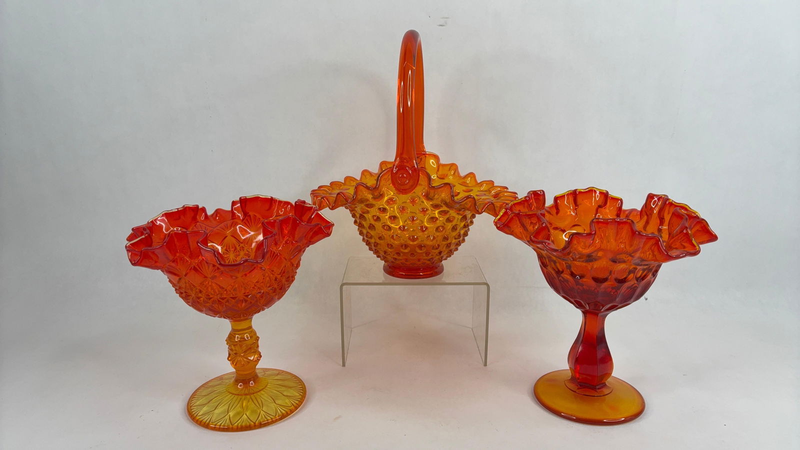 Fenton Amberina footed compotes and hobnail ruffled basket glow under UV light: .