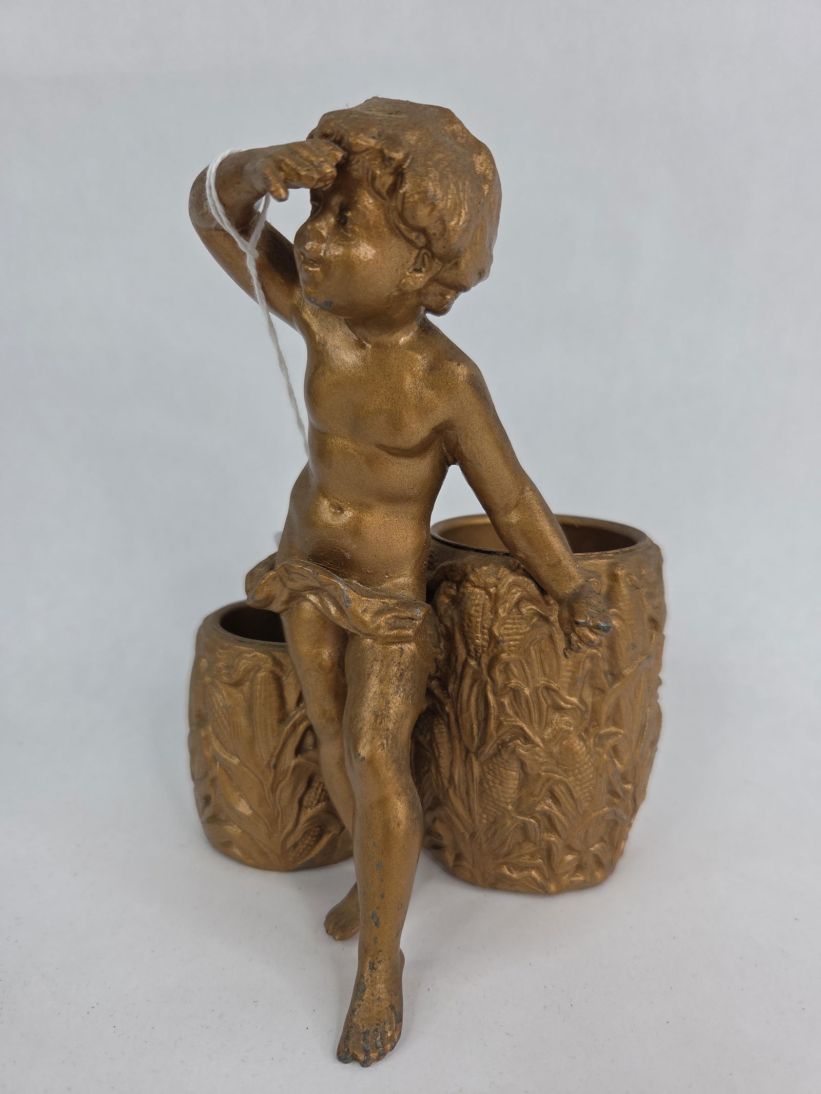 Art Deco brass cherub with ear corn barrels statue: 7 inches tall