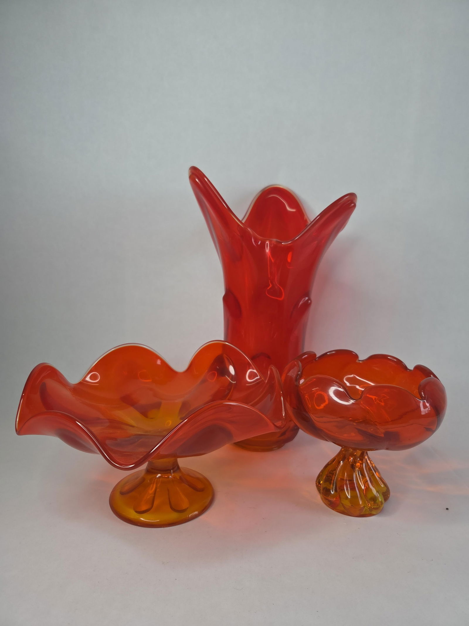 3 pcs Mid Century awesome hand made persimmon orange Viking glass collection.: includes a 14 in swung vase, and 2 footed bowls