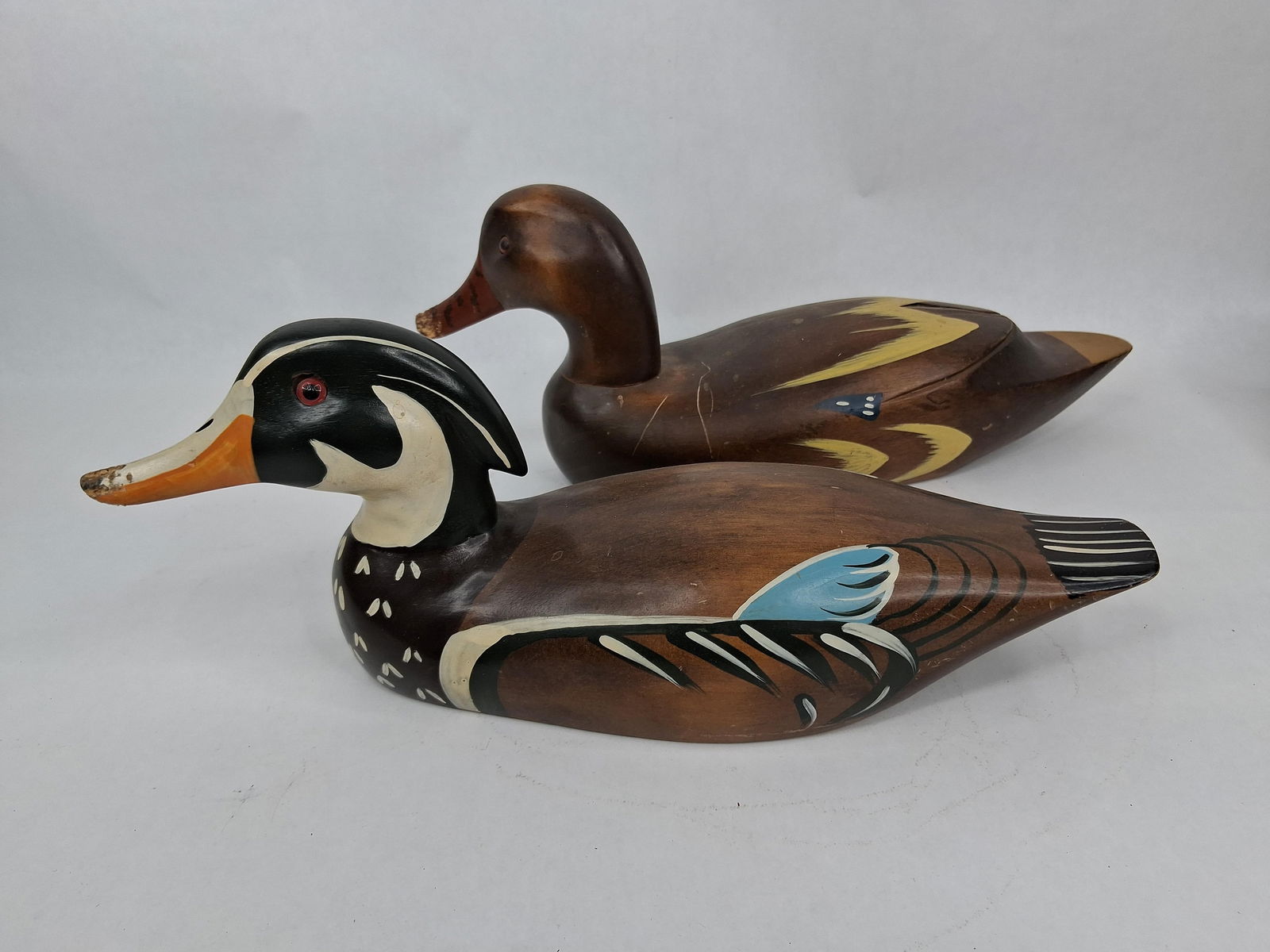 2 wooden hand painted ducks: 14 in long both have chew marks on bills