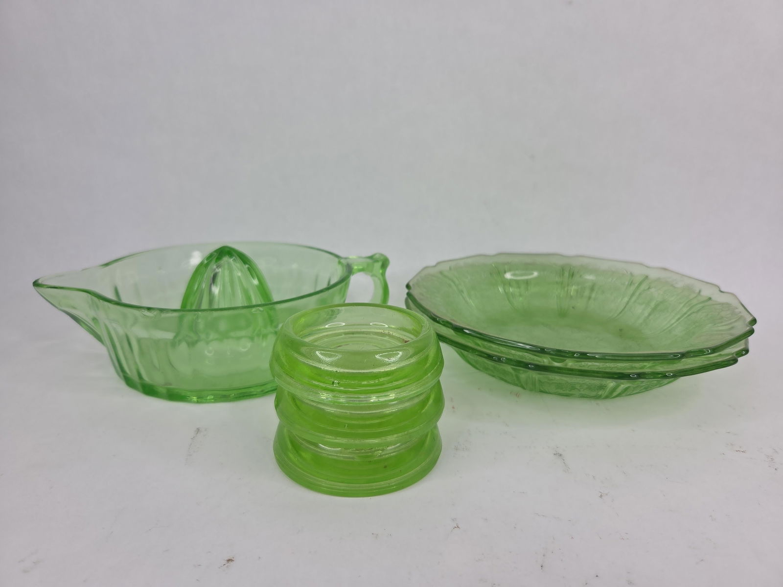 Uranium glass lot. Juicer,plates,and coasters (1 of 8)